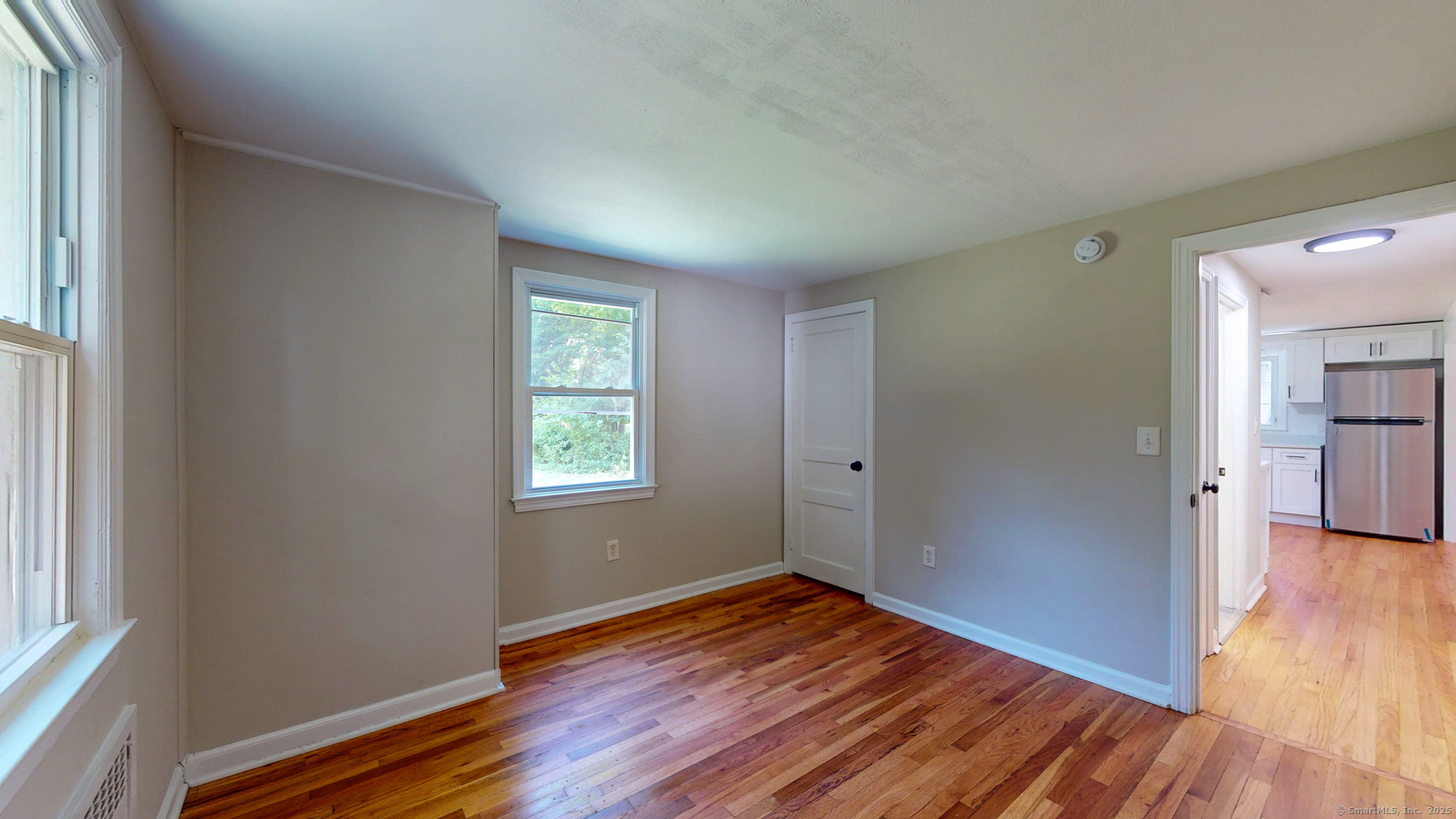 86 Gabb Road Bloomfield, CT 06002 - Photo 17 of 40 an empty room with wooden floor and windows