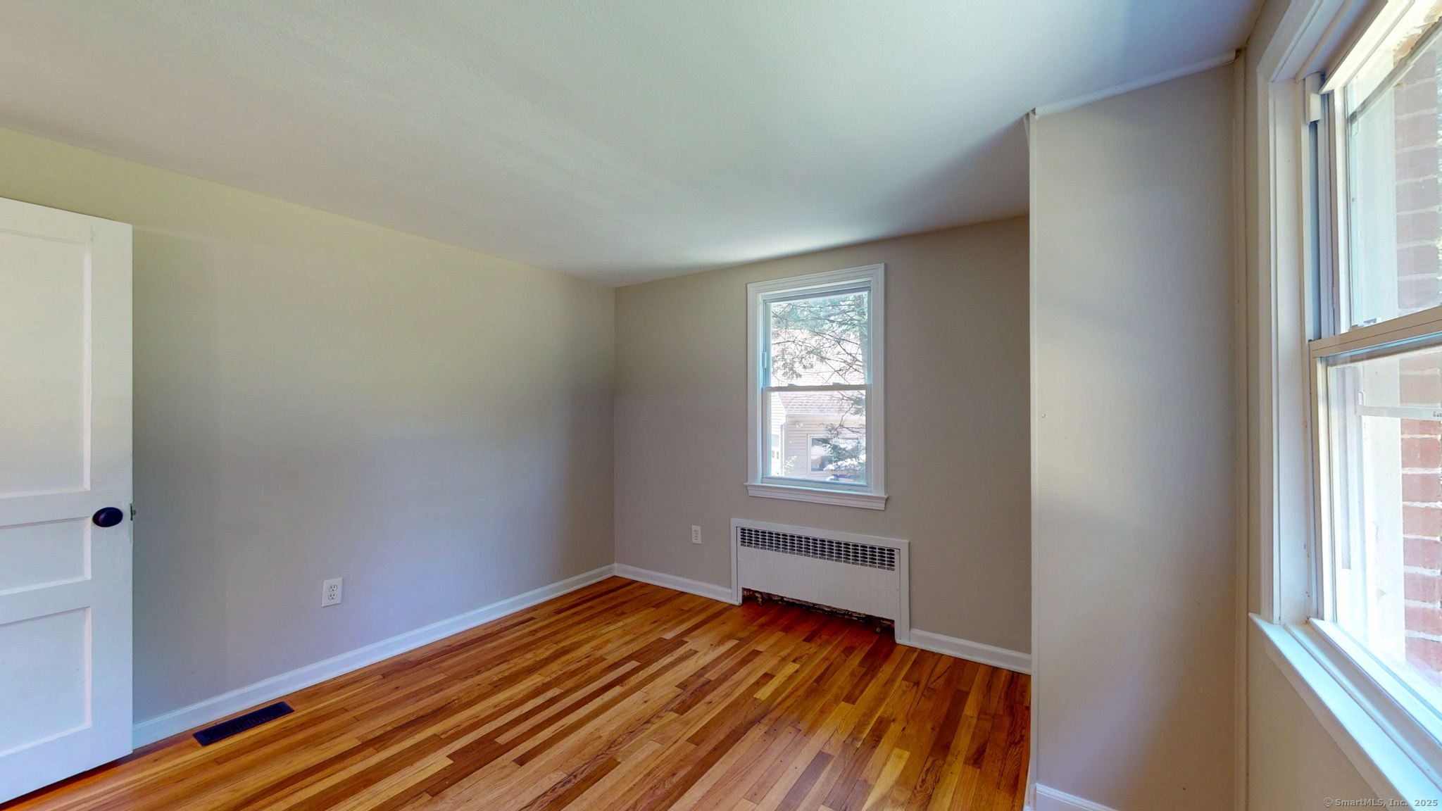 86 Gabb Road Bloomfield, CT 06002 - Photo 18 of 40 a view of an empty room with wooden floor and a window