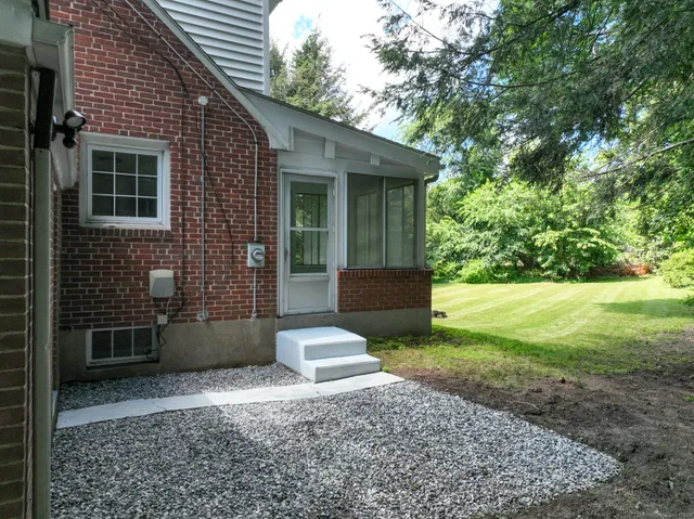 a view of a house with backyard and garden