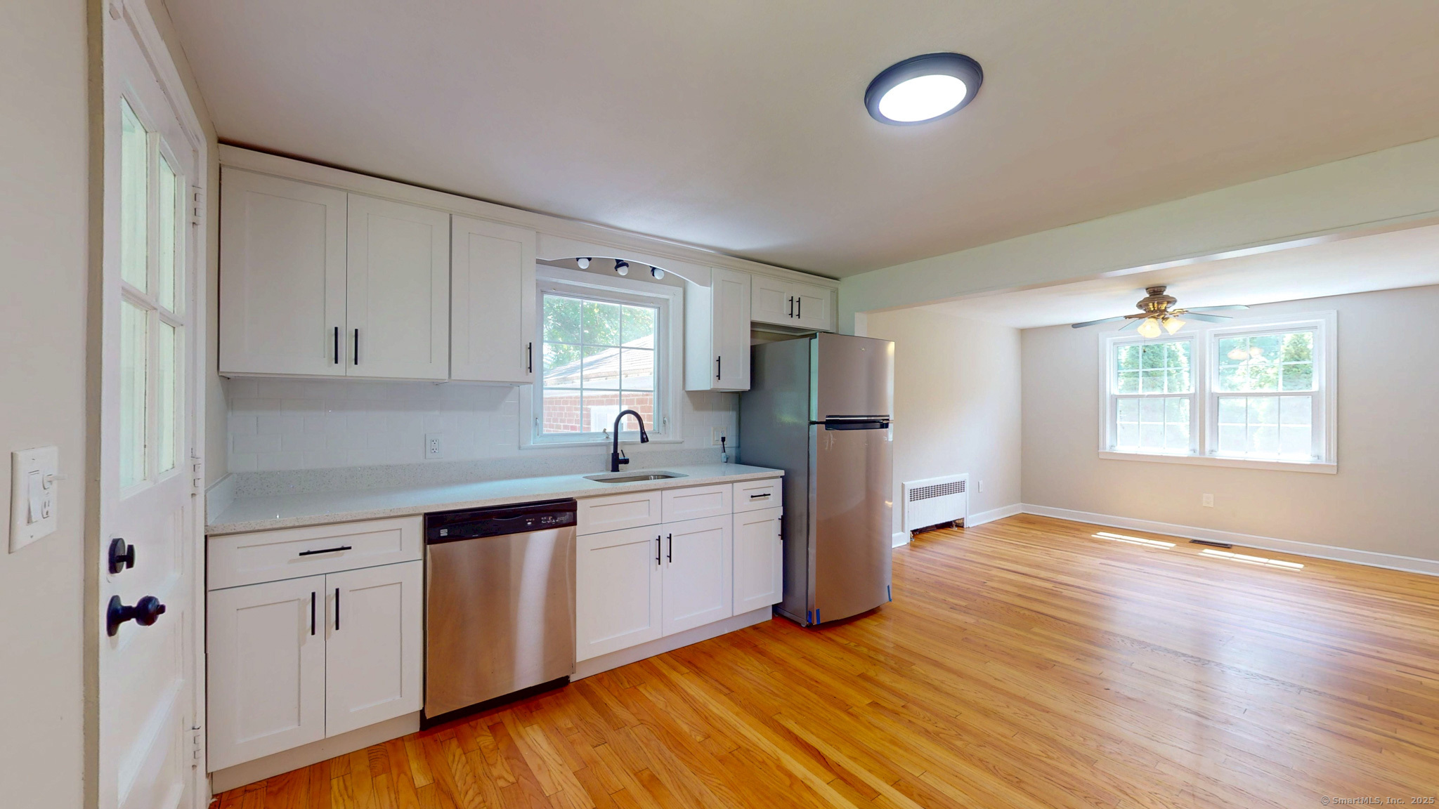 86 Gabb Road Bloomfield, CT 06002 - Photo 10 of 40 a kitchen with wooden floors and white cabinets