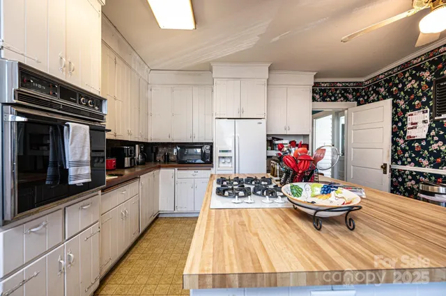 a view of a hallway with wooden floor and a dining table