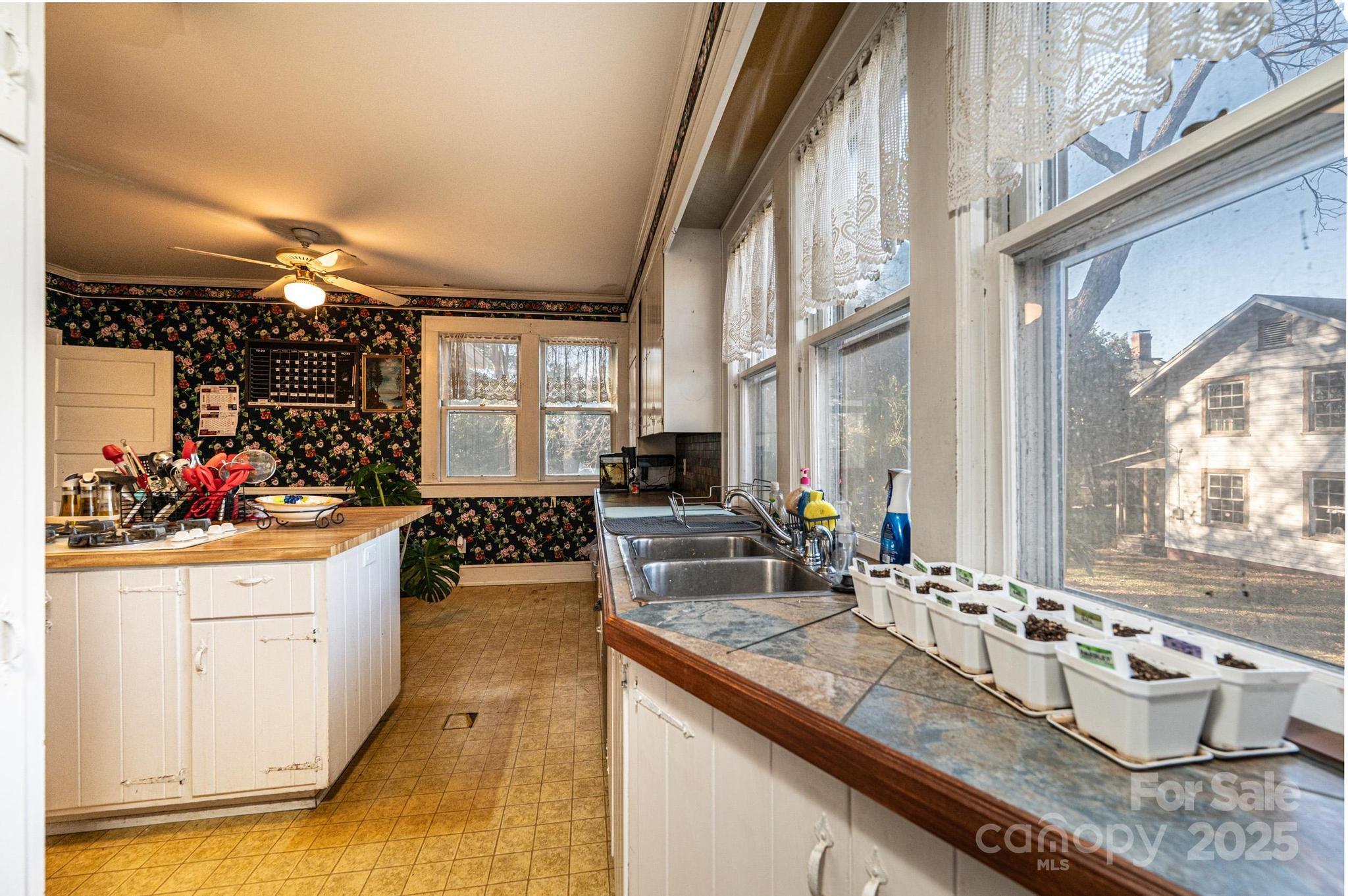 221 3rd Street Northeast Hickory, NC 28601 - Photo 18 of 40 a kitchen with stainless steel appliances granite countertop a sink and cabinets