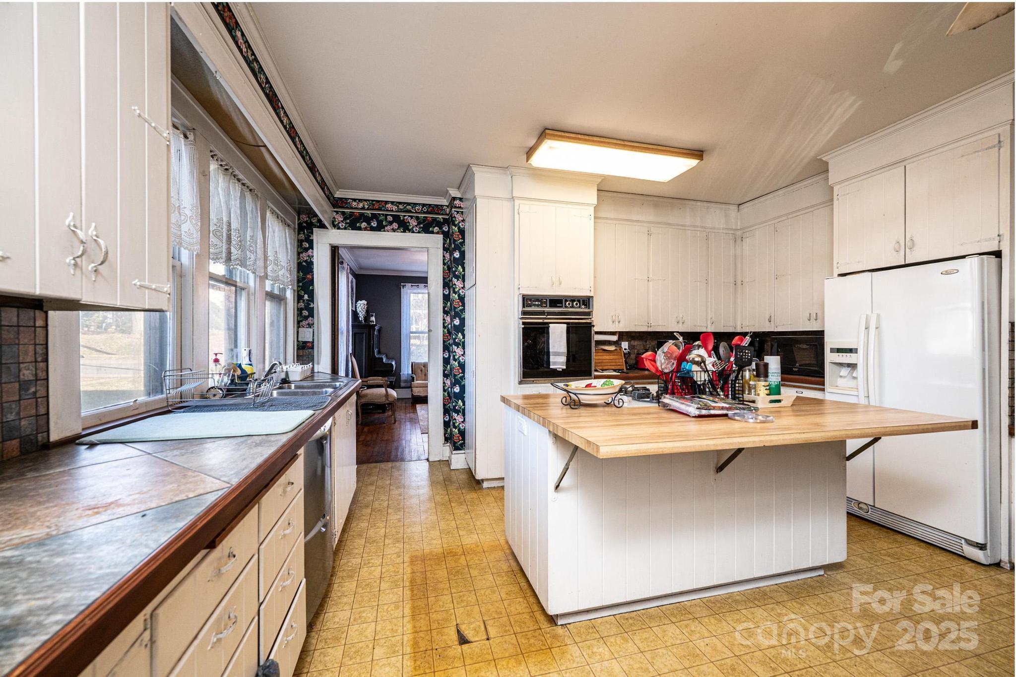 221 3rd Street Northeast Hickory, NC 28601 - Photo 19 of 40 a large kitchen with stainless steel appliances granite countertop a lot of counter space and wooden floor