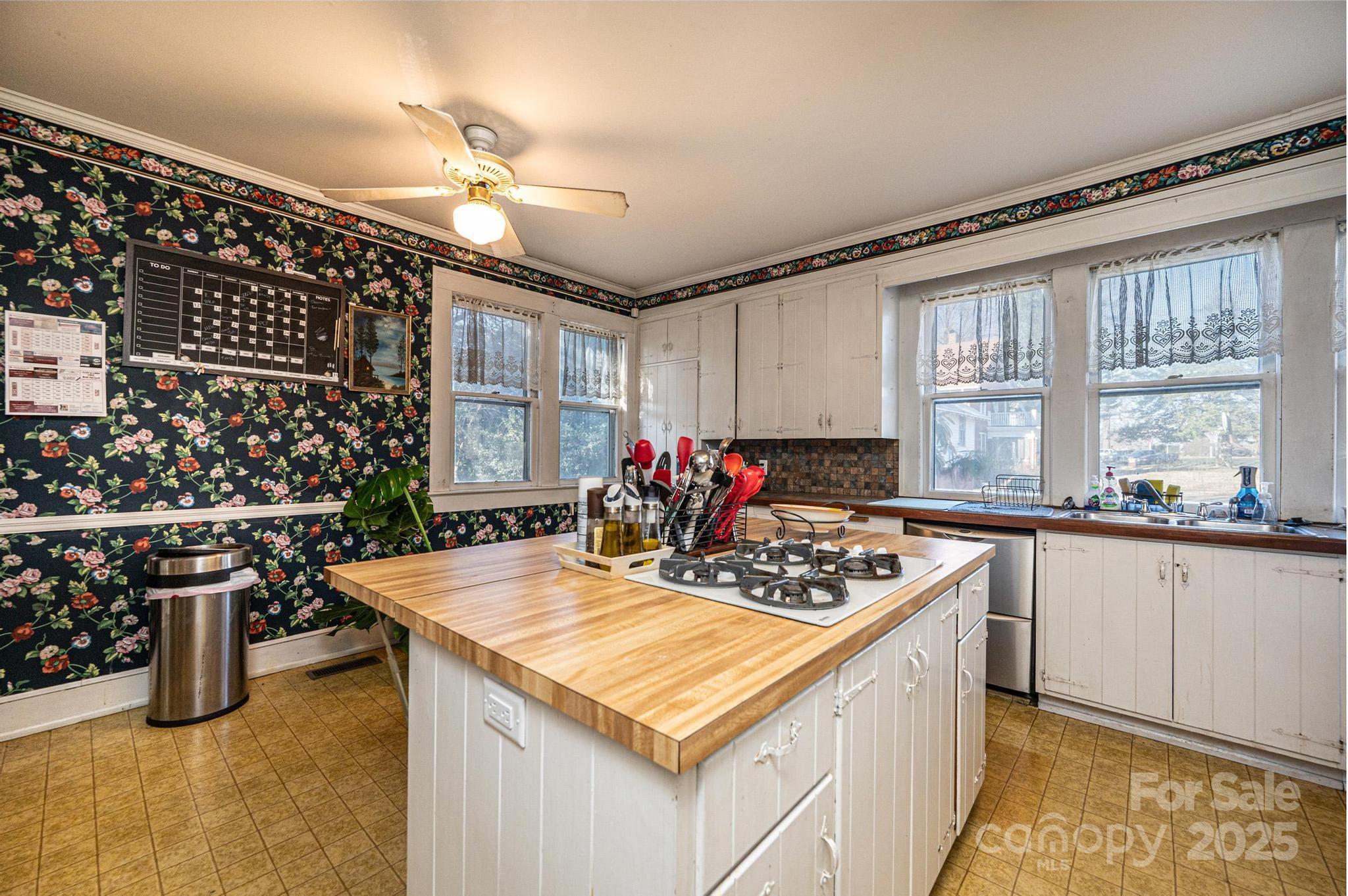 221 3rd Street Northeast Hickory, NC 28601 - Photo 20 of 40 a kitchen with a sink a stove and chairs
