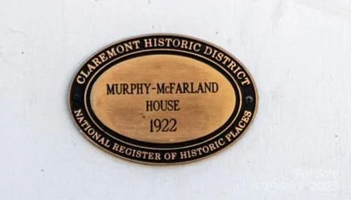 a living room with furniture a chandelier and a floor to ceiling window