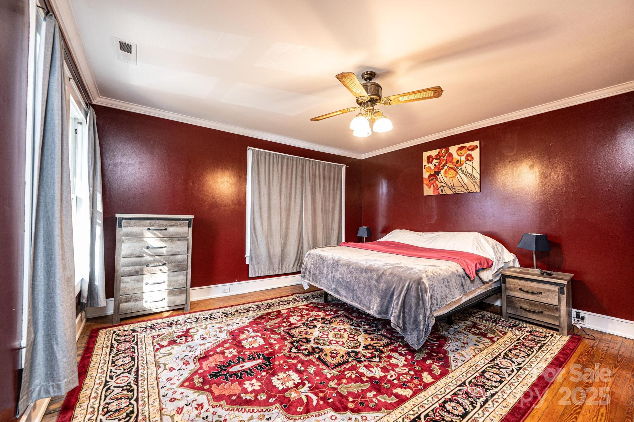 221 3rd Street Northeast Hickory, NC 28601 - Photo 29 of 40 a bedroom with a bed and a chandelier