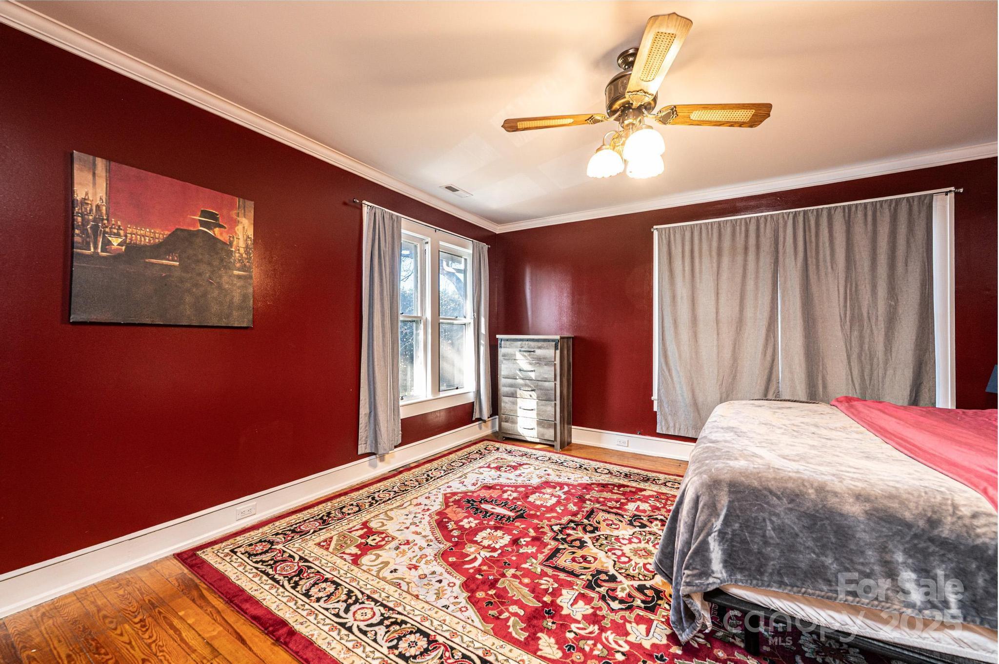 221 3rd Street Northeast Hickory, NC 28601 - Photo 30 of 40 a bedroom with a bed and a chandelier