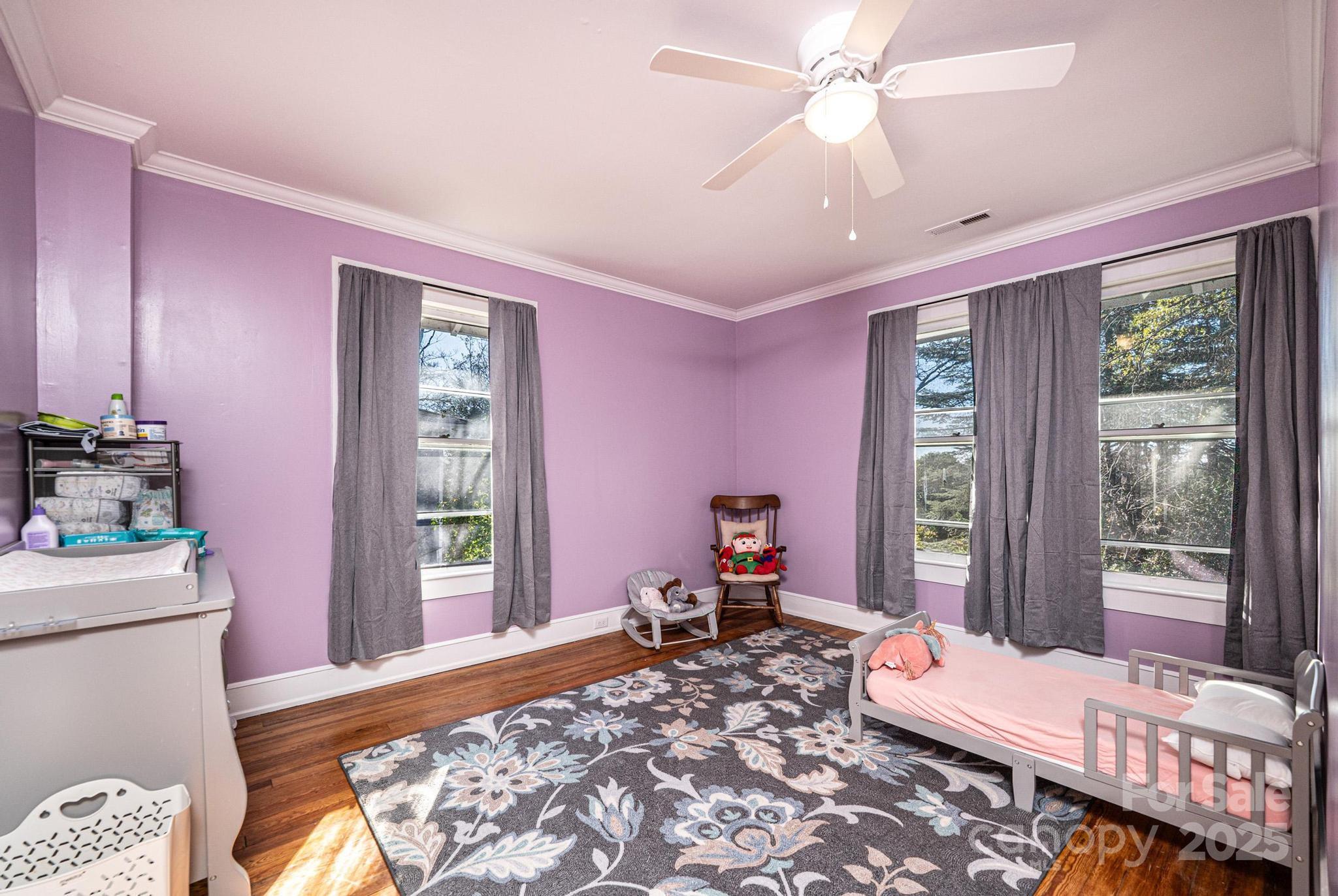 221 3rd Street Northeast Hickory, NC 28601 - Photo 32 of 40 a bedroom with a bed and wooden floor