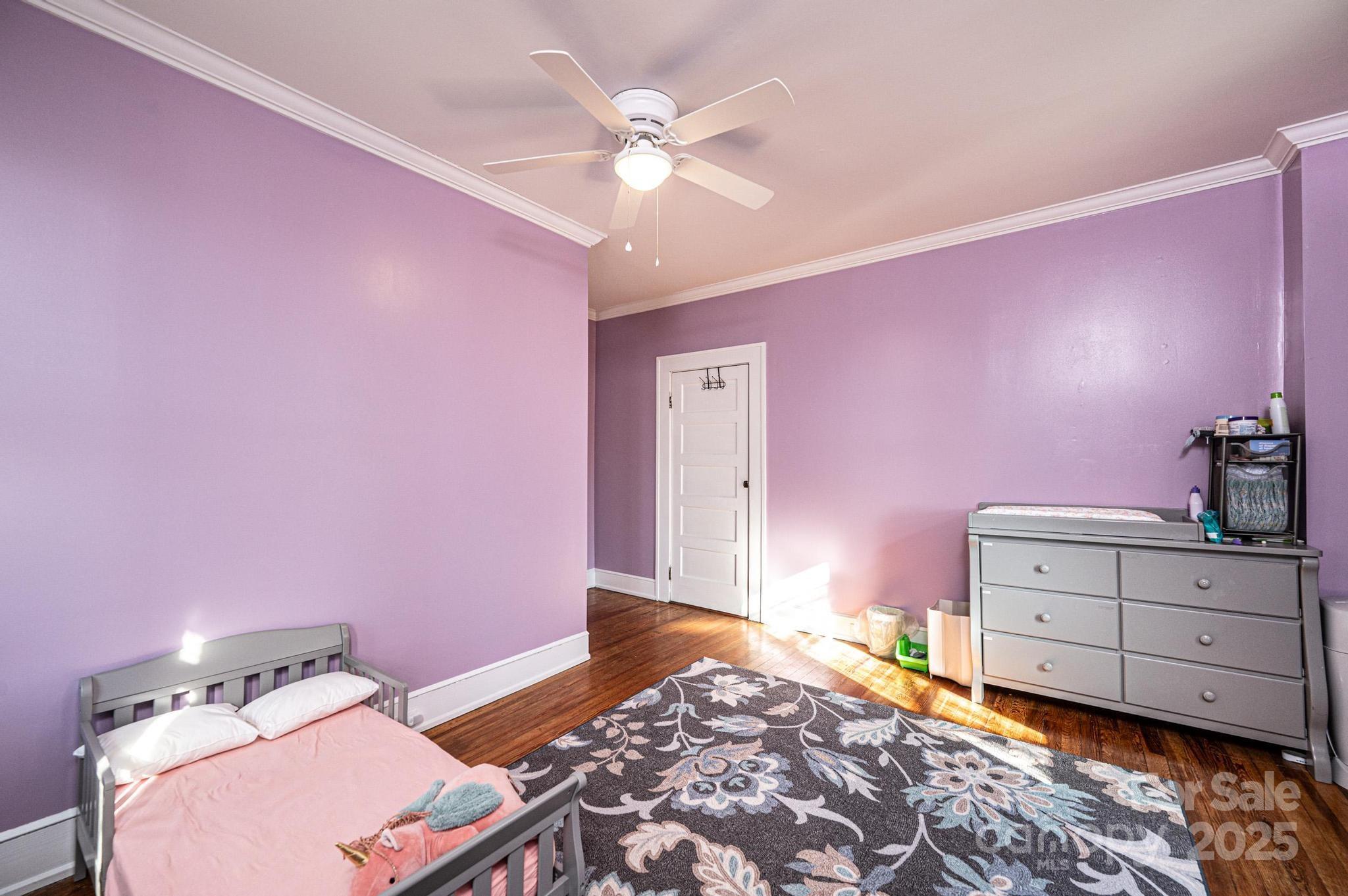 221 3rd Street Northeast Hickory, NC 28601 - Photo 33 of 40 a bedroom with a bed and a chandelier fan