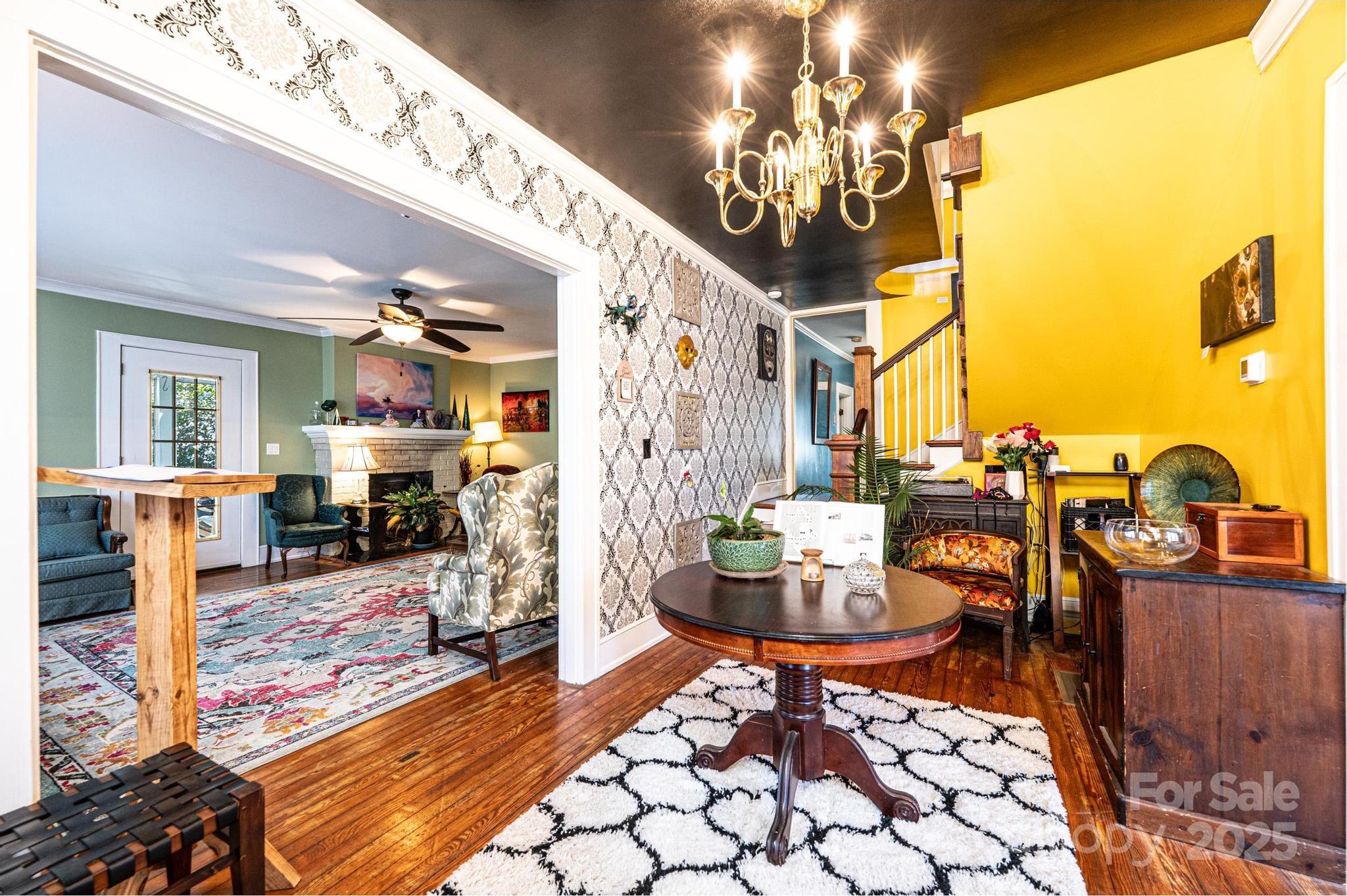 221 3rd Street Northeast Hickory, NC 28601 - Photo 5 of 40 a living room with fireplace furniture and a chandelier