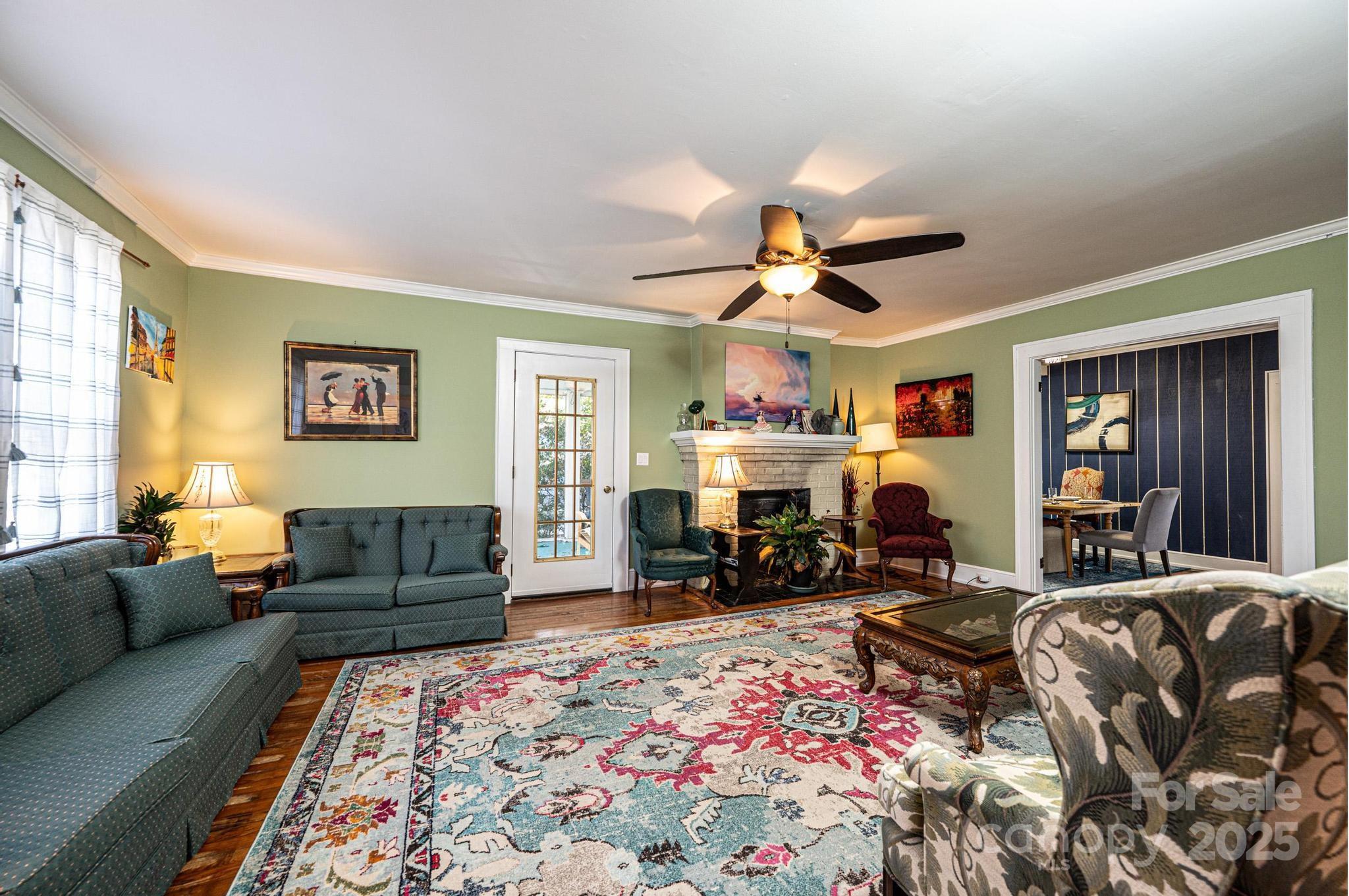 221 3rd Street Northeast Hickory, NC 28601 - Photo 8 of 40 a living room with furniture ceiling fan and a rug