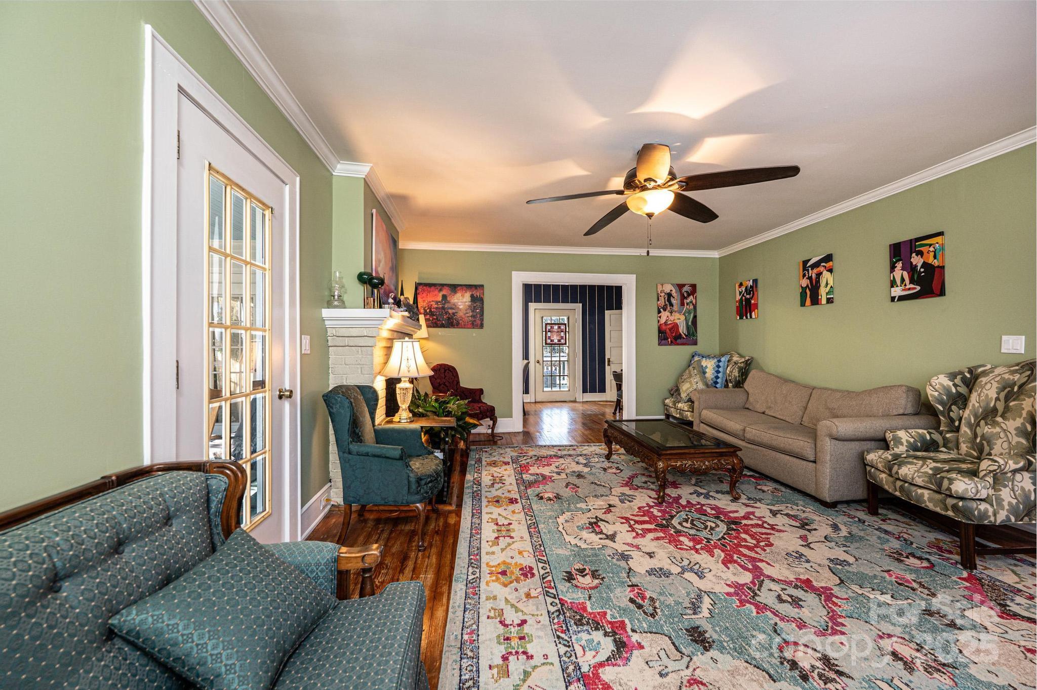 221 3rd Street Northeast Hickory, NC 28601 - Photo 9 of 40 a living room with furniture or couch and a chandelier
