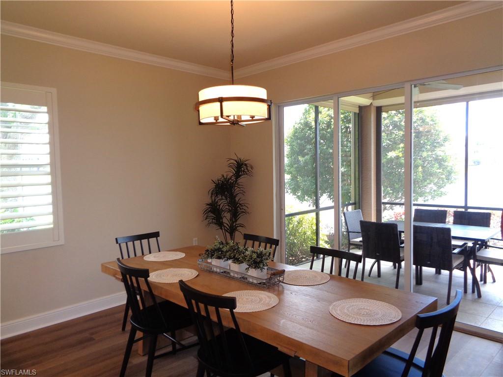 734 Regency Reserve Circle, Unit 2701 Naples, FL 34119 - Photo 15 of 37 a view of a dining room with furniture window and wooden floor