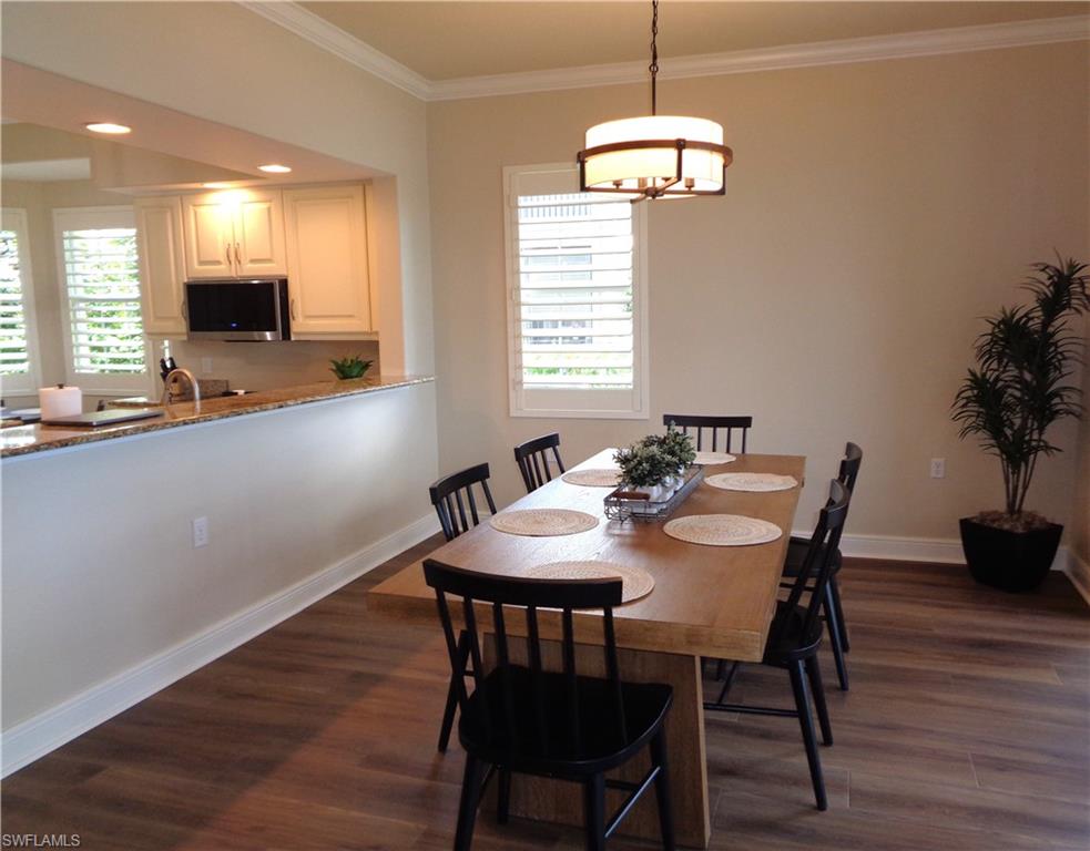 734 Regency Reserve Circle, Unit 2701 Naples, FL 34119 - Photo 17 of 37 a view of a dining room with furniture window and wooden floor