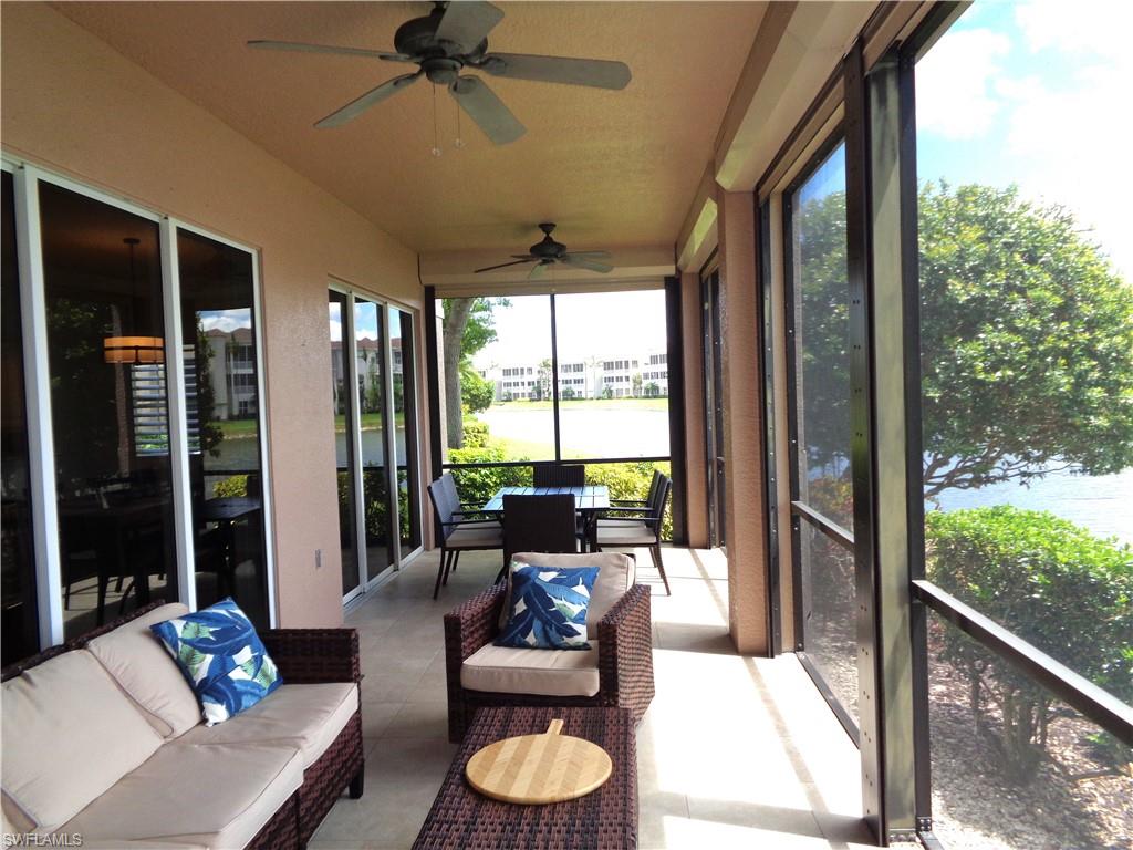 734 Regency Reserve Circle, Unit 2701 Naples, FL 34119 - Photo 28 of 37 a living room with furniture and a floor to ceiling window