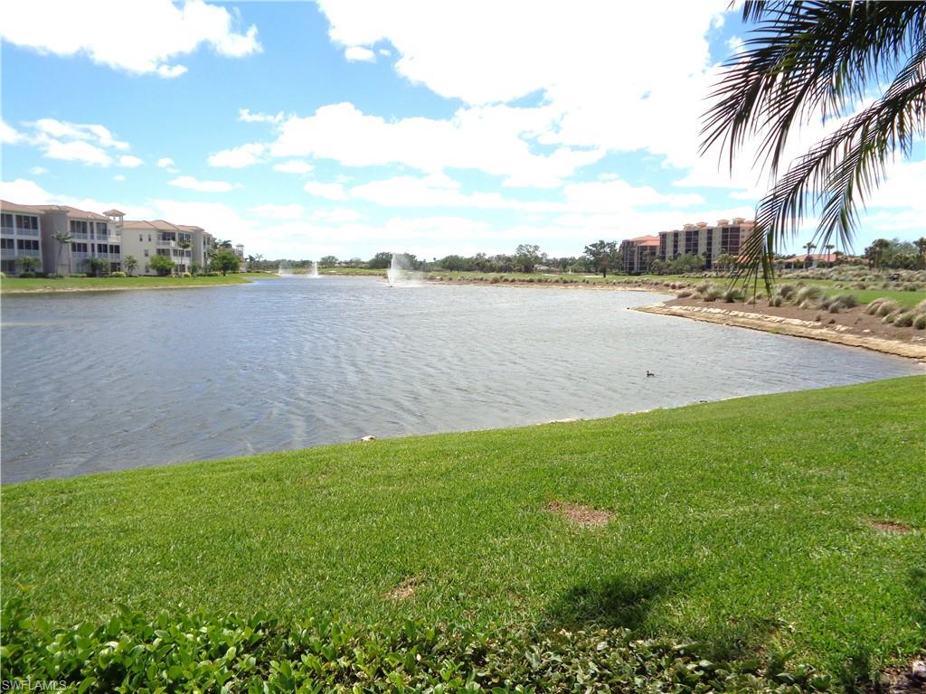 734 Regency Reserve Circle, Unit 2701 Naples, FL 34119 - Photo 35 of 37 a view of a lake with houses in the back
