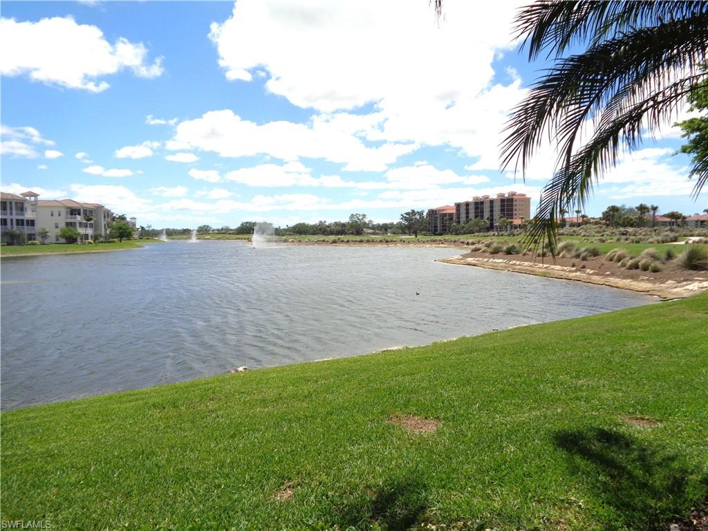 734 Regency Reserve Circle, Unit 2701 Naples, FL 34119 - Photo 36 of 37 a view of a lake with houses in the back