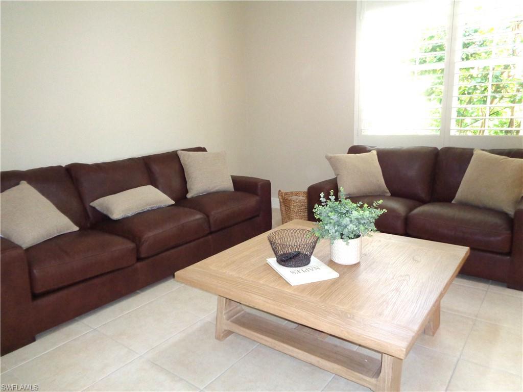 734 Regency Reserve Circle, Unit 2701 Naples, FL 34119 - Photo 4 of 37 a living room with furniture and a potted plant