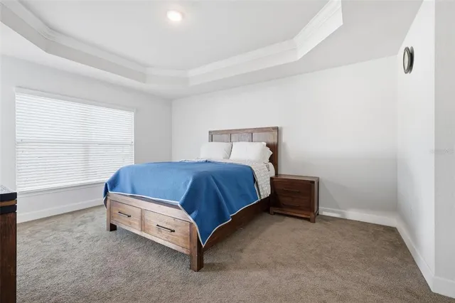 a bed sitting in a room next to a window