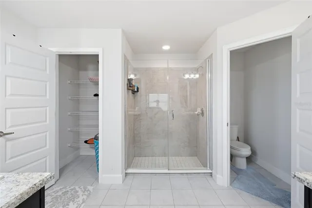a bathroom with a shower and toilet