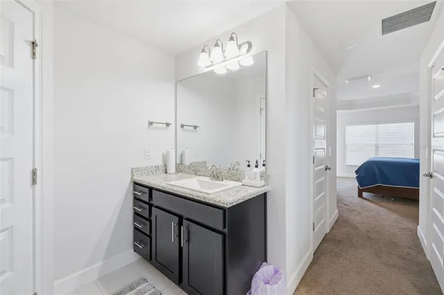 a en suite bathroom with a sink and a mirror