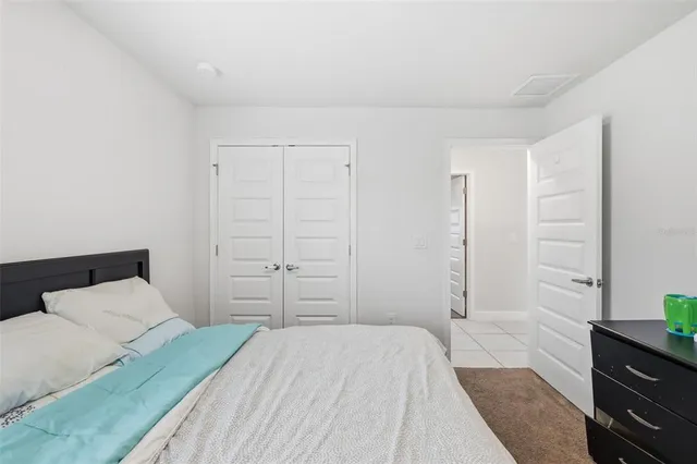 a bedroom with a bed and a dresser