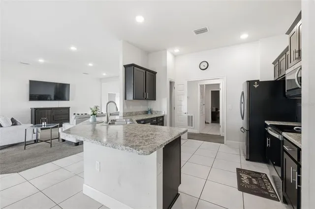 a kitchen with a sink microwave and refrigerator