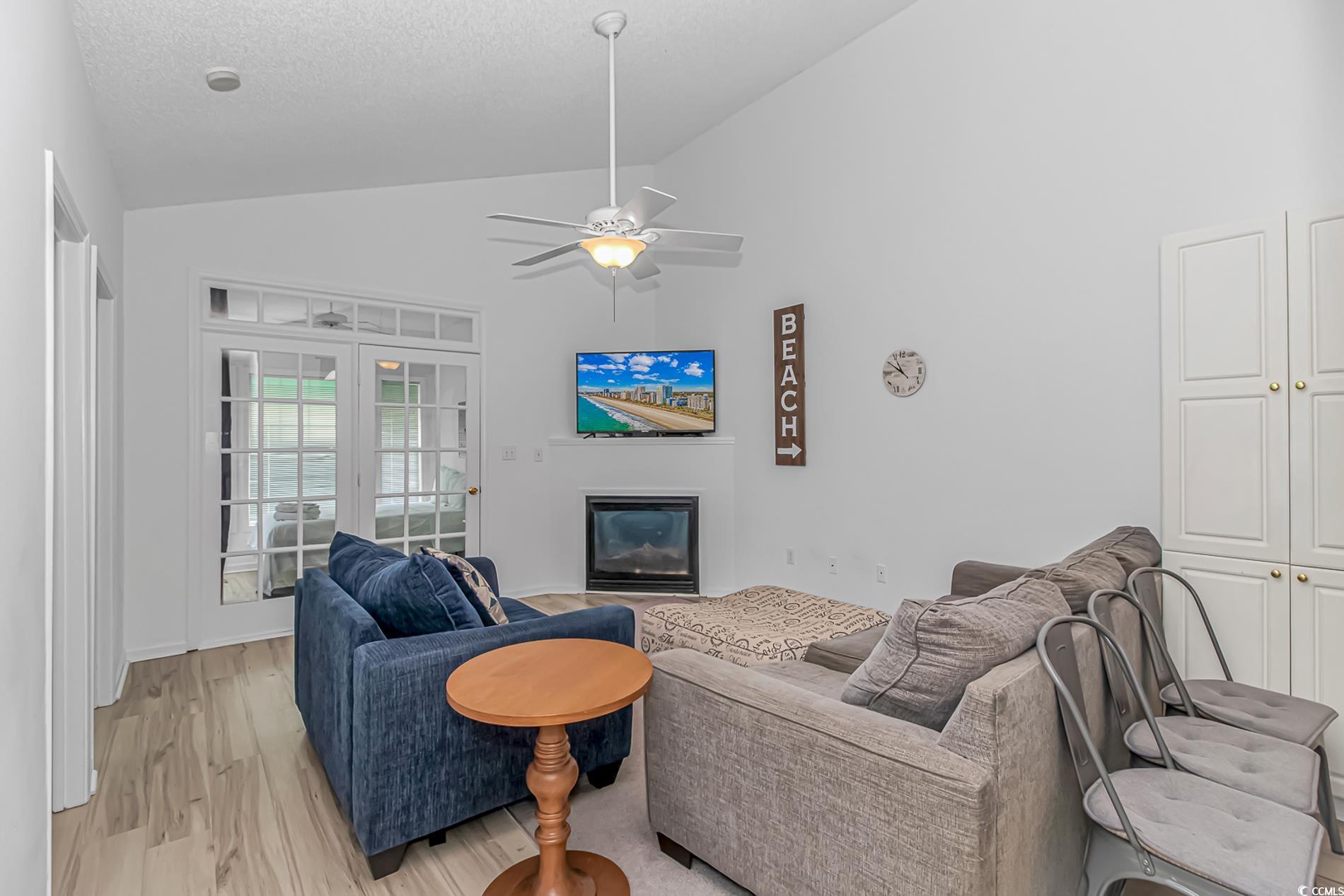 9754 Leyland Drive, Unit 9 Myrtle Beach, SC 29572 - Photo 12 of 40 Living area with a glass covered fireplace, light