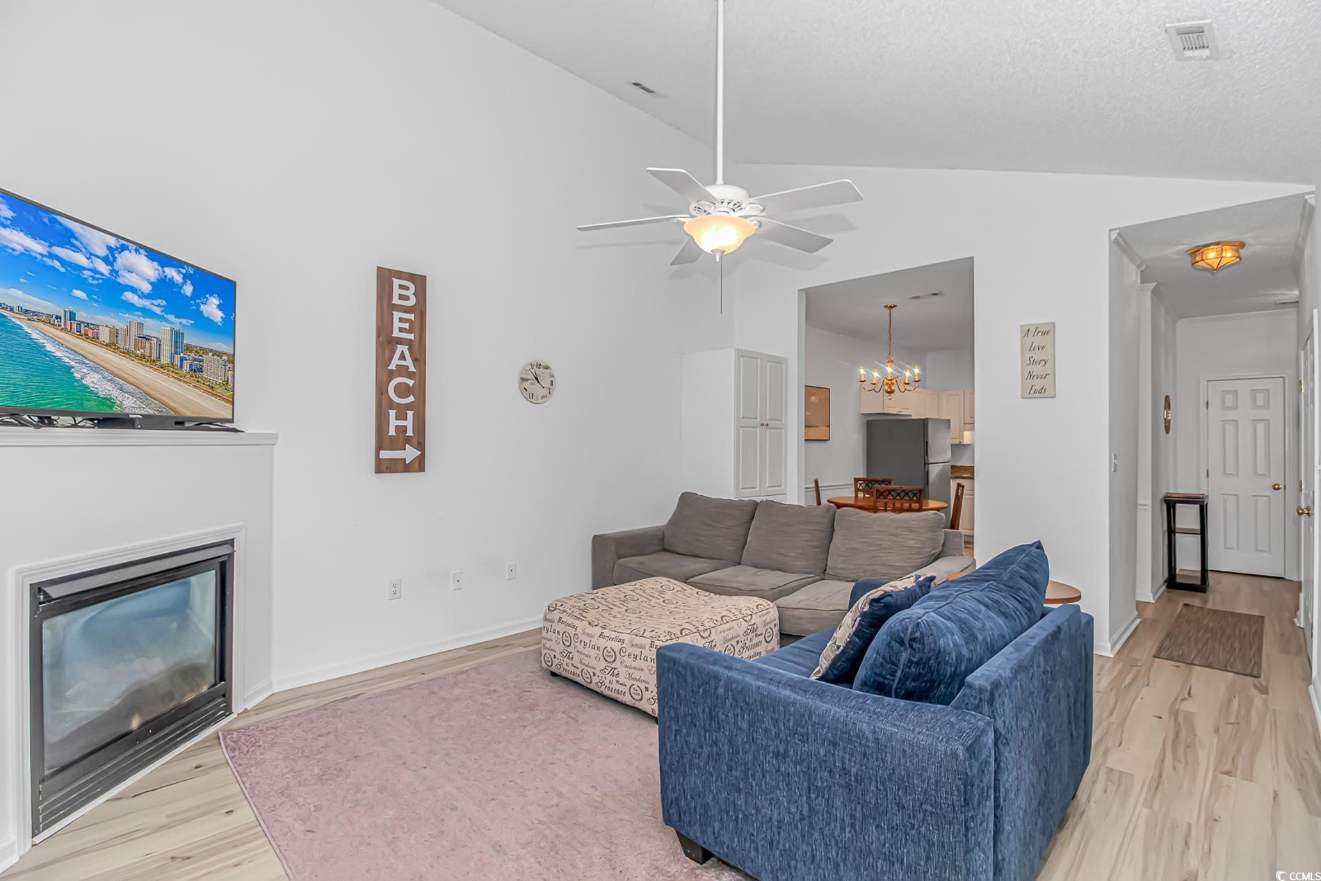 9754 Leyland Drive, Unit 9 Myrtle Beach, SC 29572 - Photo 14 of 40 Living area featuring a chandelier, a glass covere