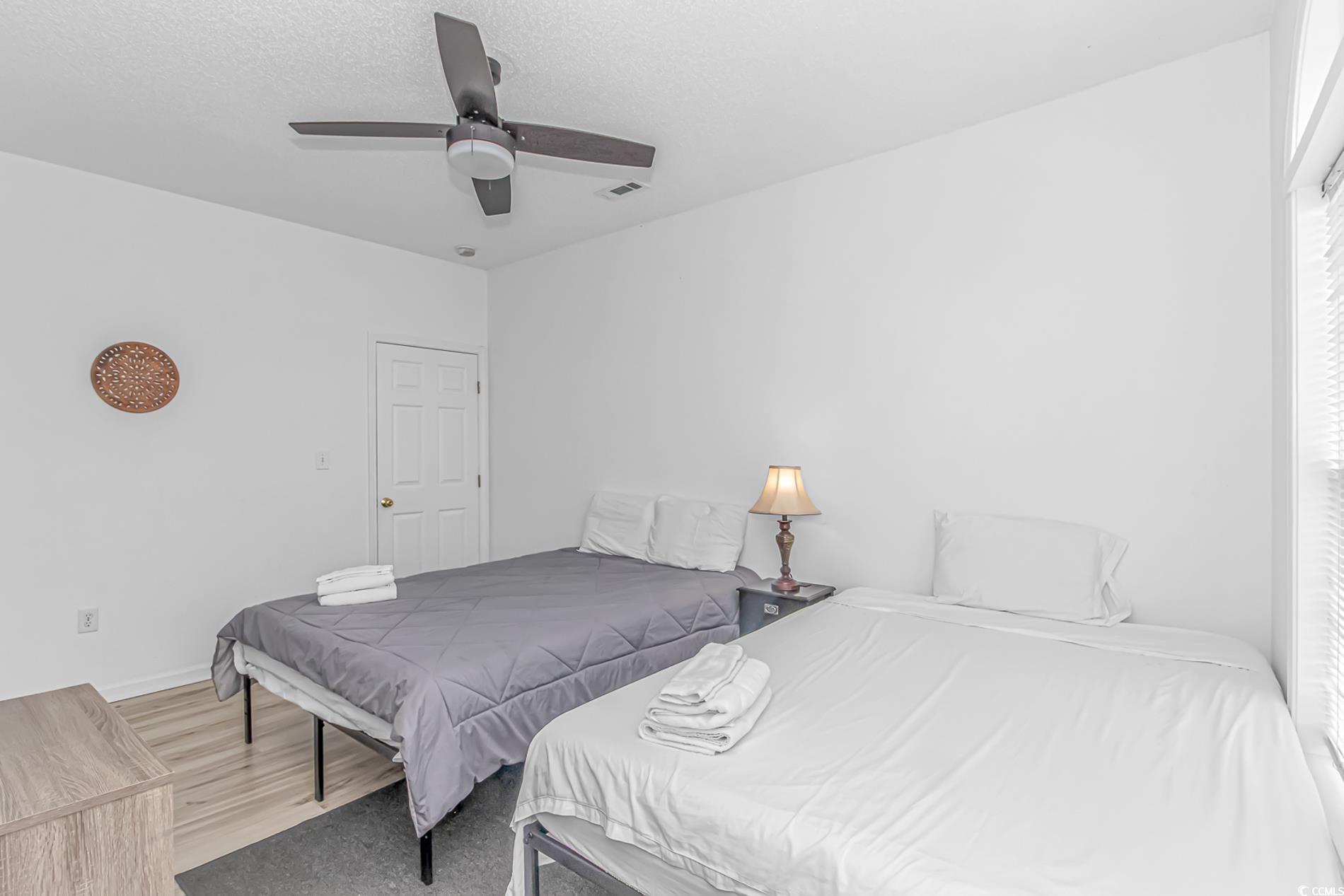 9754 Leyland Drive, Unit 9 Myrtle Beach, SC 29572 - Photo 22 of 40 Bedroom with wood finished floors, ceiling fan, an