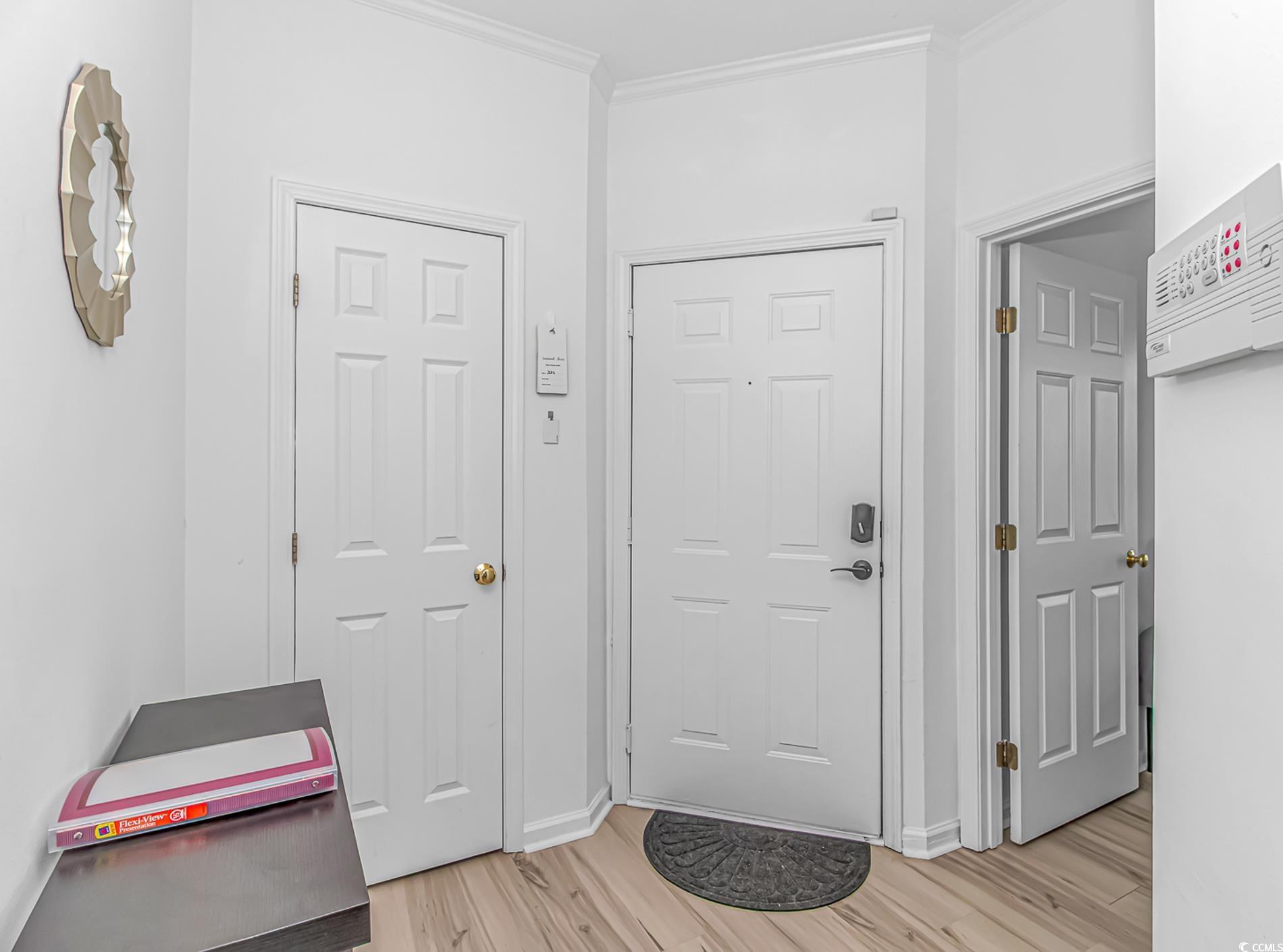 9754 Leyland Drive, Unit 9 Myrtle Beach, SC 29572 - Photo 5 of 40 Foyer featuring light wood-style flooring and orna