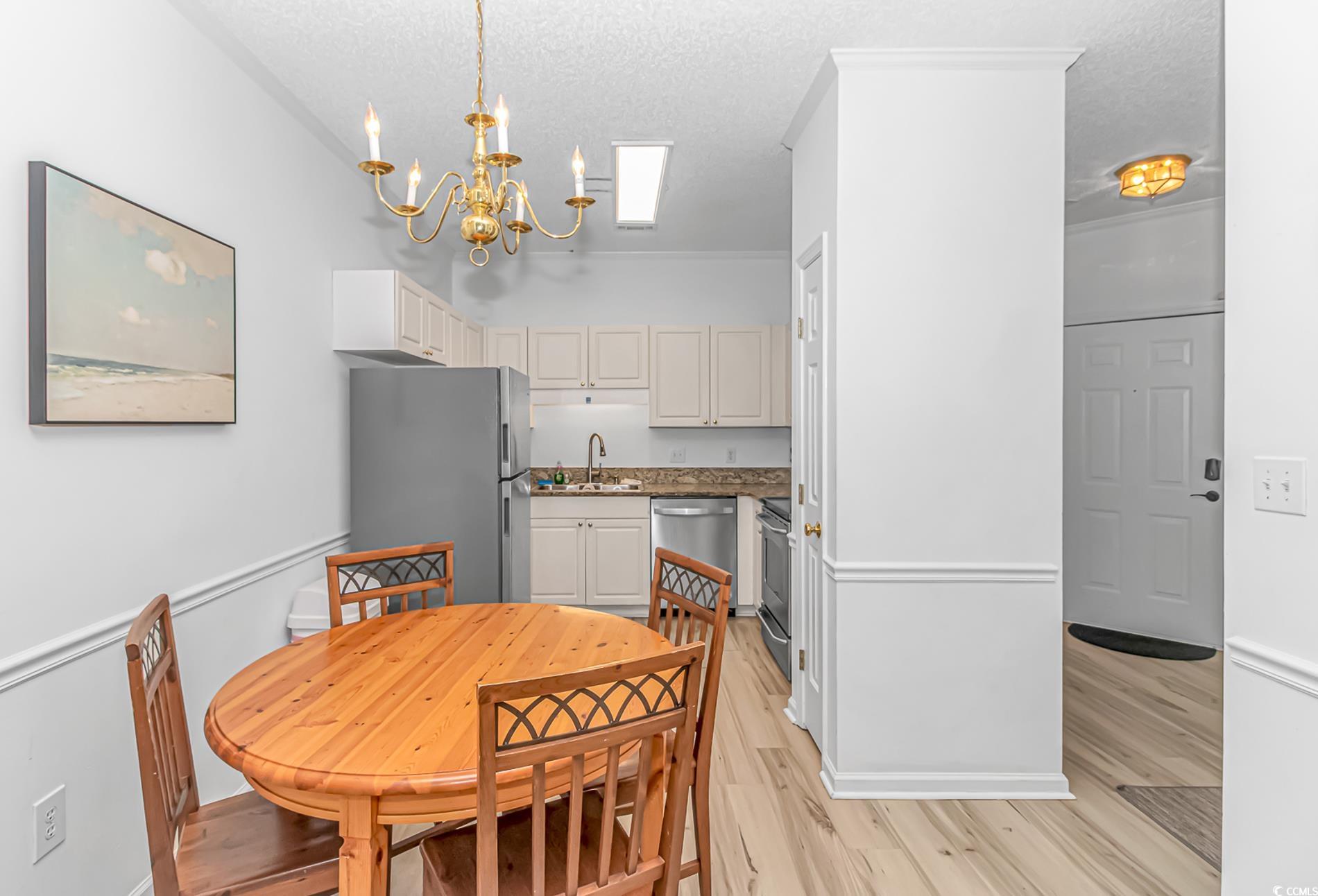 9754 Leyland Drive, Unit 9 Myrtle Beach, SC 29572 - Photo 6 of 40 Dining space with light wood-type flooring, a text