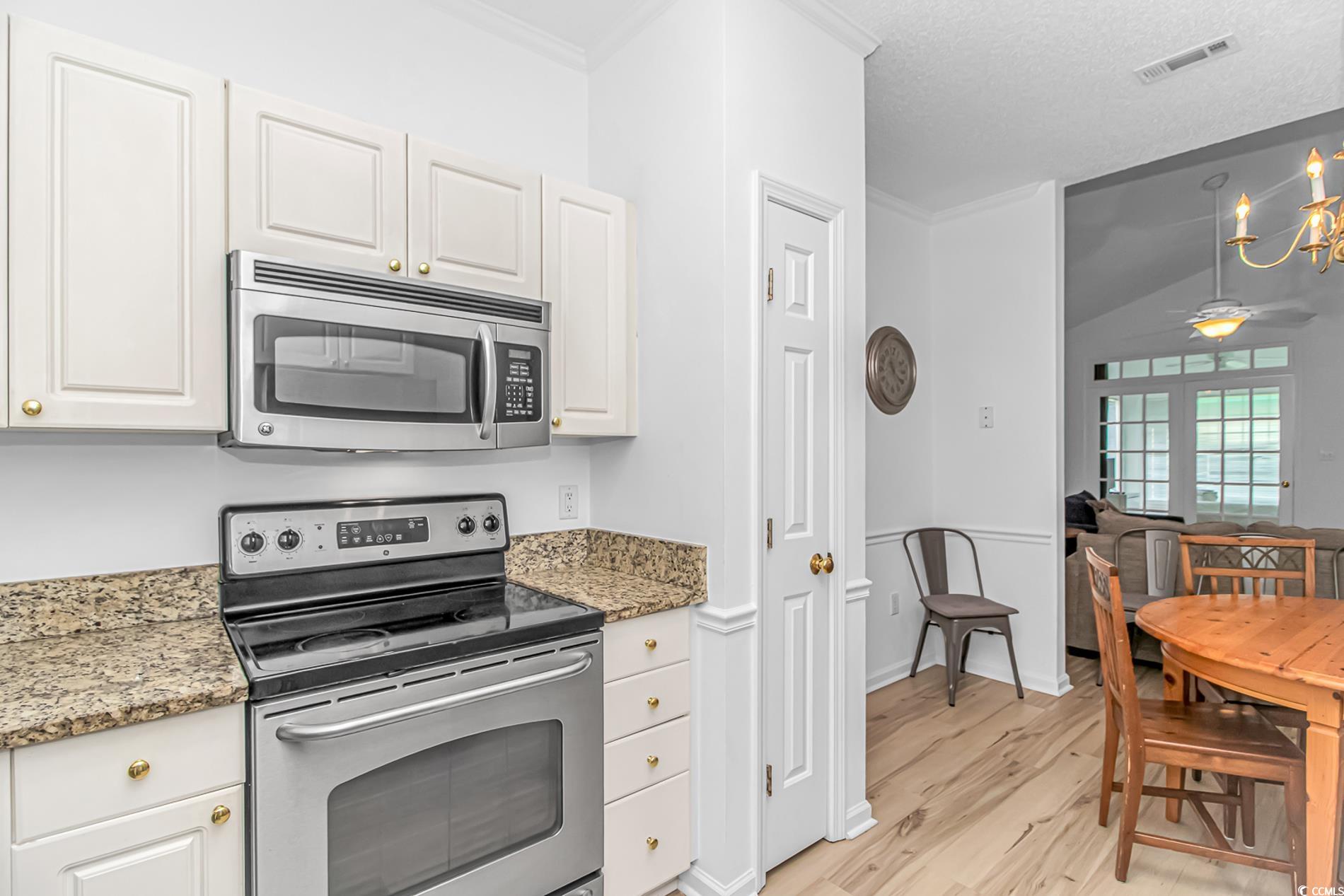 9754 Leyland Drive, Unit 9 Myrtle Beach, SC 29572 - Photo 8 of 40 Kitchen with stainless steel appliances, vaulted c
