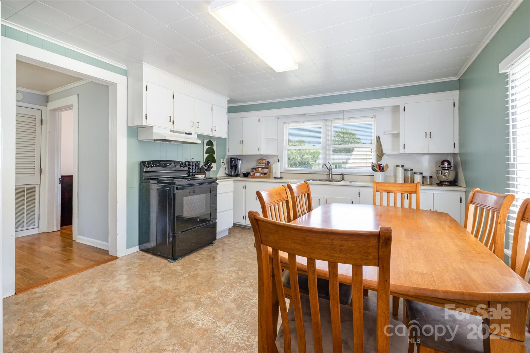 811 Cleveland Avenue Grover, NC 28073 - Photo 14 of 43 a kitchen with granite countertop a stove a sink a dining table and chairs