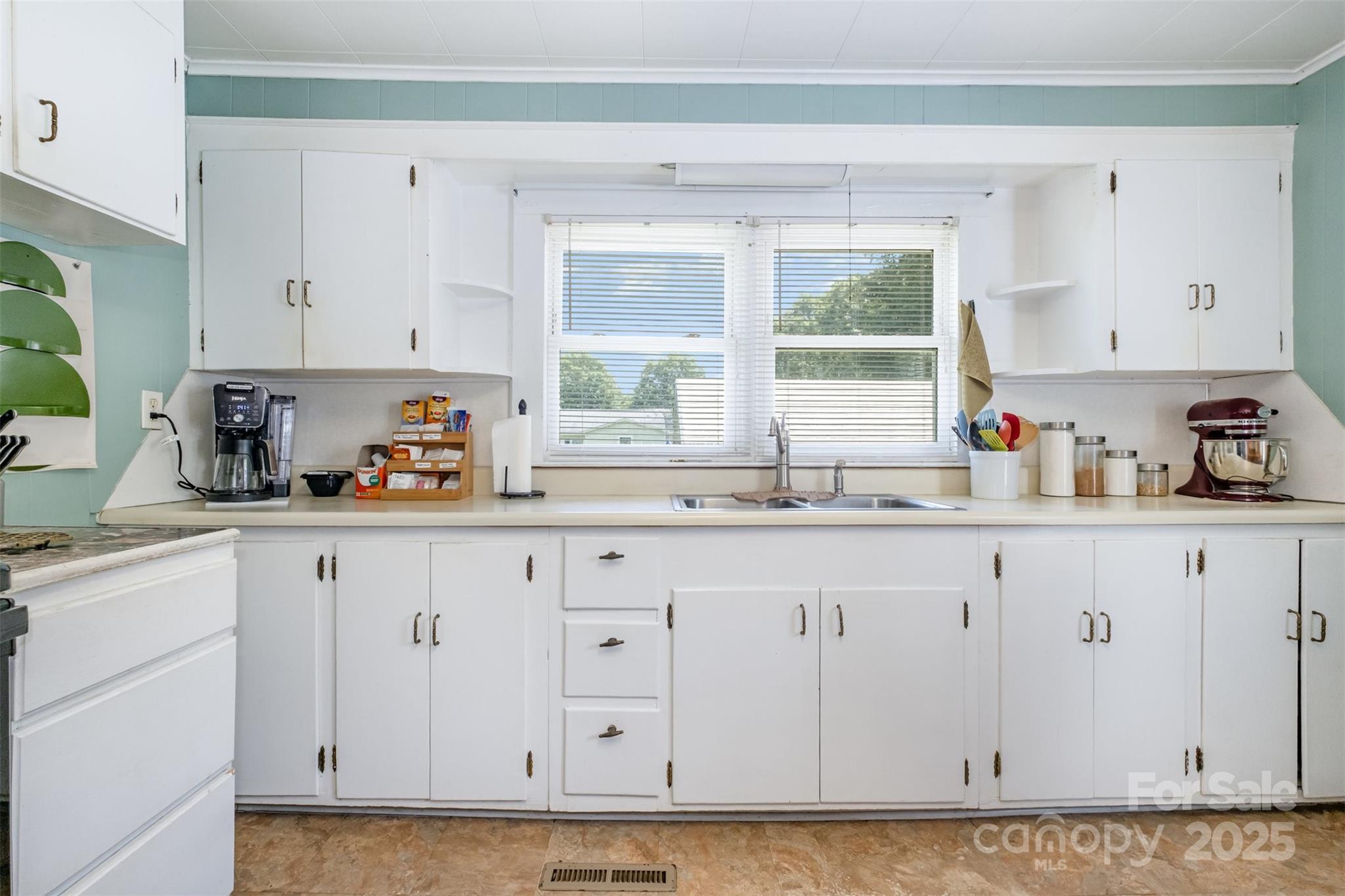 811 Cleveland Avenue Grover, NC 28073 - Photo 16 of 43 a kitchen with granite countertop white cabinets and window