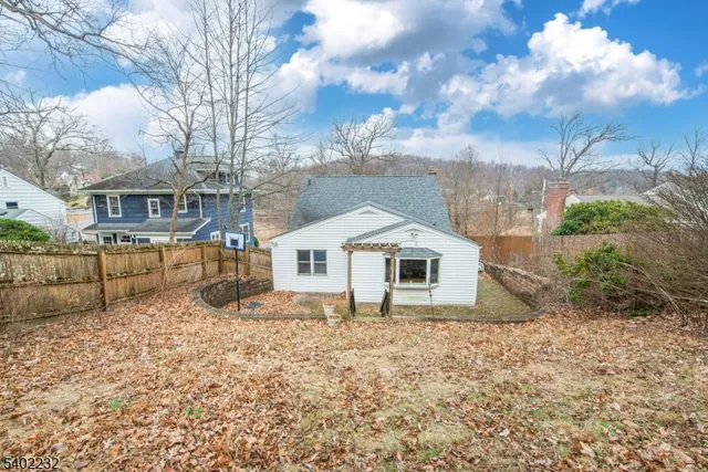 a front view of a house with a yard covered with snow