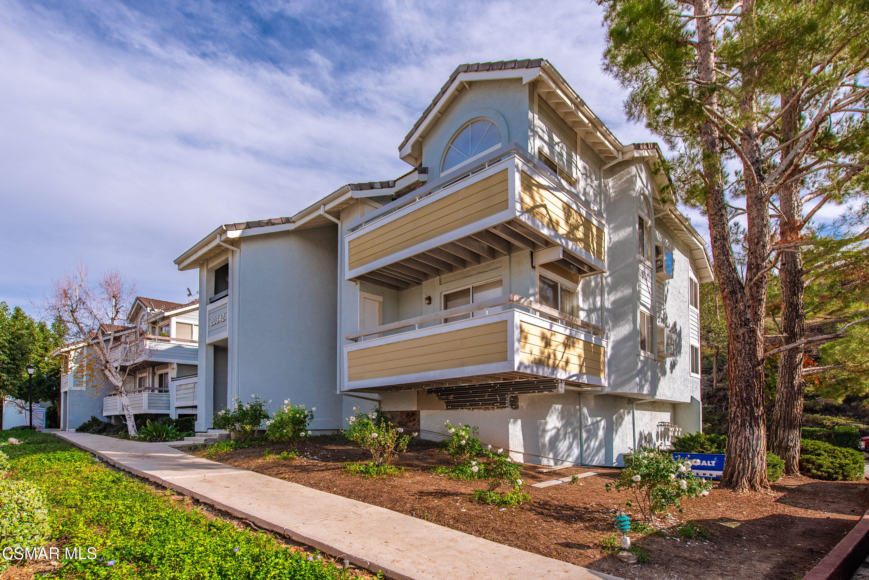 20342 Rue Crevier, Unit 613 Canyon Country, CA 91351 - Photo 1 of 36 a front view of a house with garden