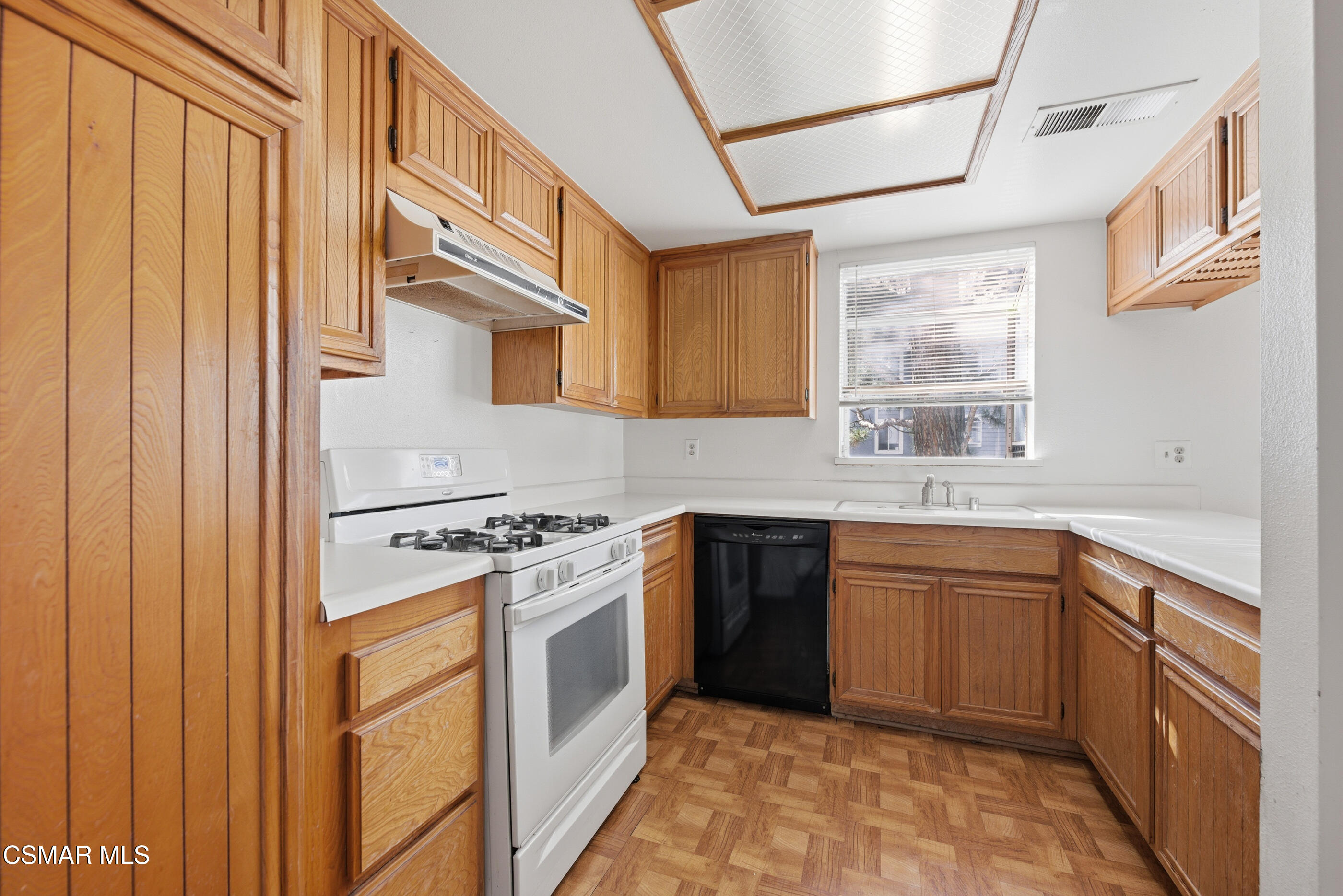 20342 Rue Crevier, Unit 613 Canyon Country, CA 91351 - Photo 11 of 36 a kitchen with stainless steel appliances granite countertop a stove and a sink