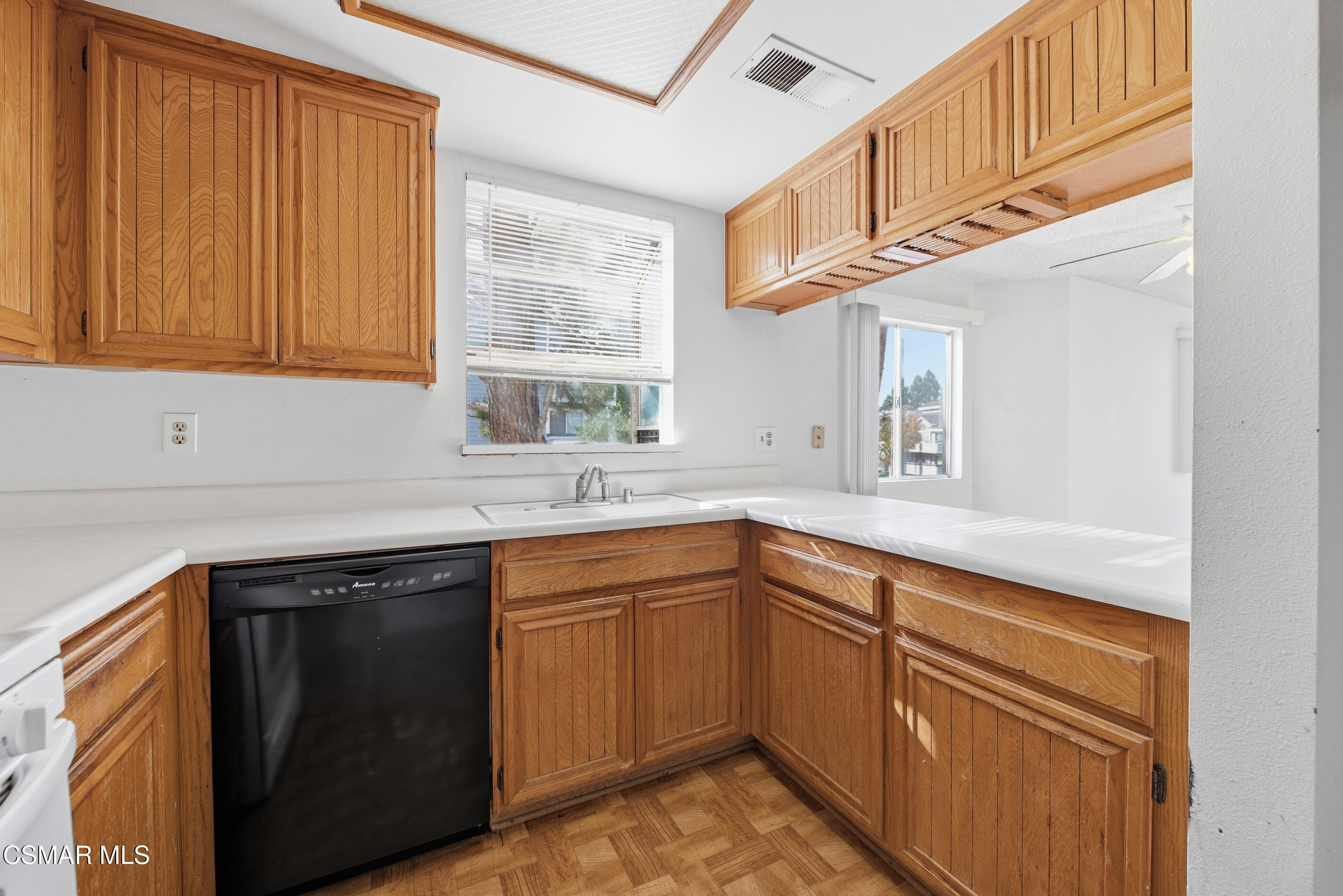 20342 Rue Crevier, Unit 613 Canyon Country, CA 91351 - Photo 12 of 36 a kitchen with stainless steel appliances granite countertop cabinets sink and window