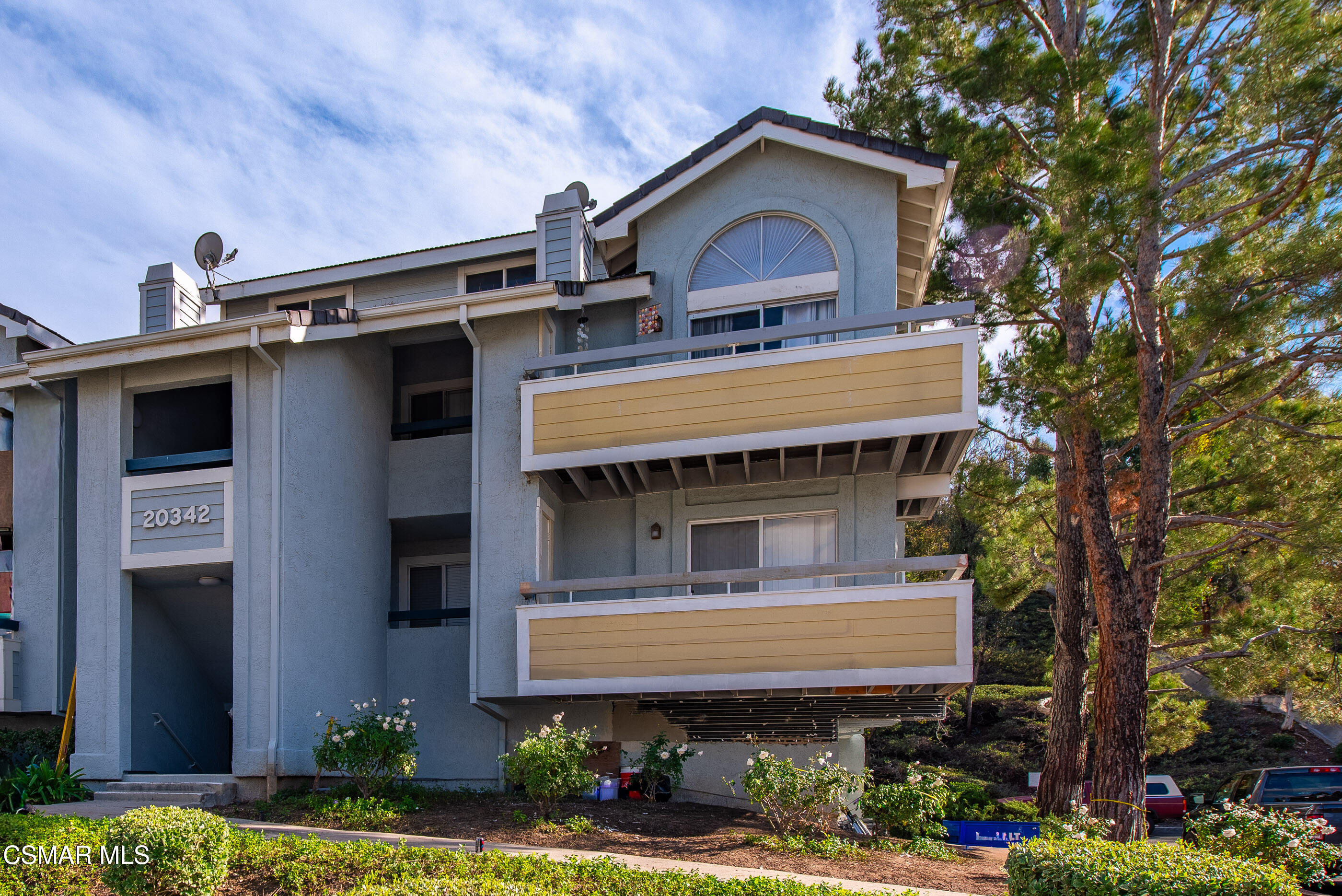20342 Rue Crevier, Unit 613 Canyon Country, CA 91351 - Photo 2 of 36 a front view of a house with a garden