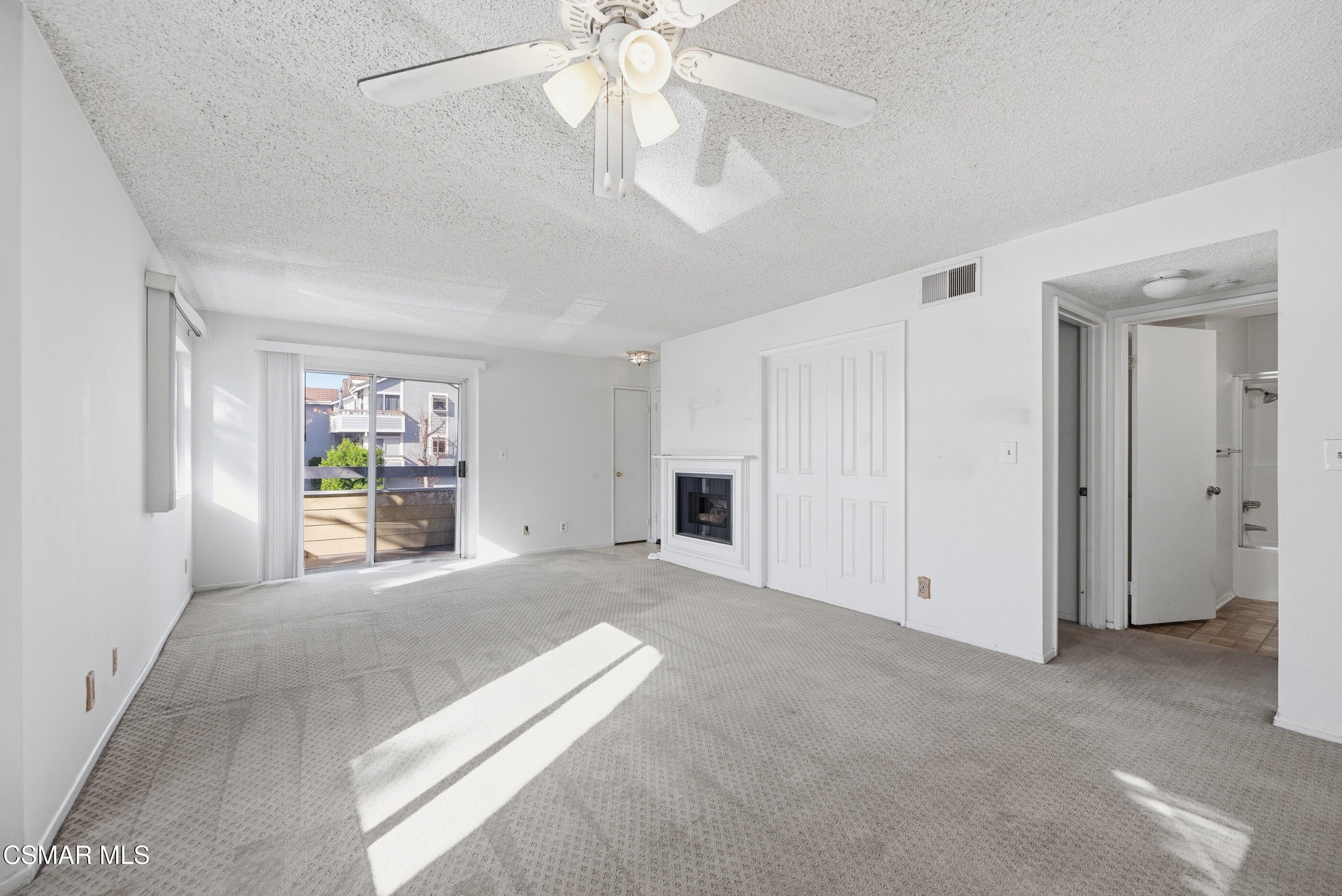 20342 Rue Crevier, Unit 613 Canyon Country, CA 91351 - Photo 10 of 36 a view of a livingroom with an empty space and a ceiling fan
