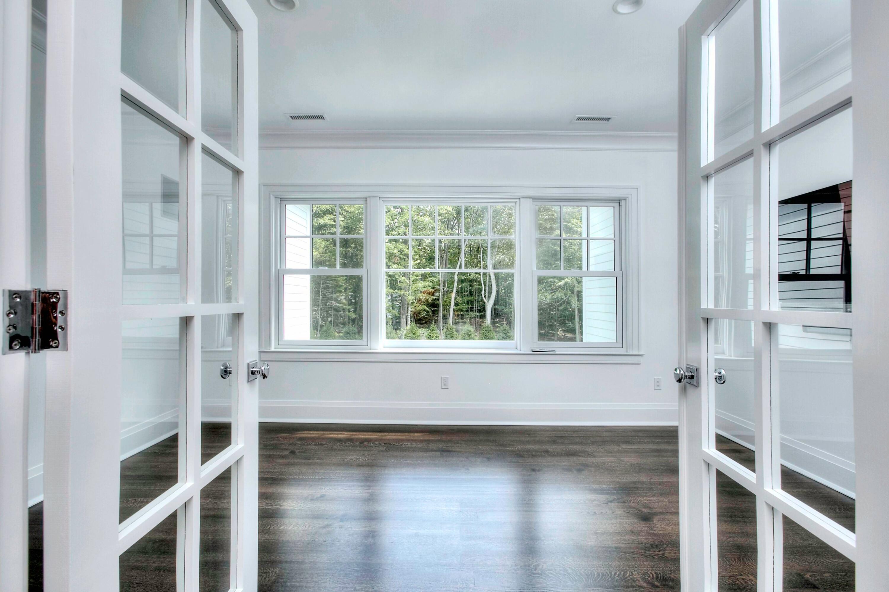 293 Laurel Road New Canaan, CT 06840 - Photo 22 of 42 a view of an empty room with wooden floor and a window
