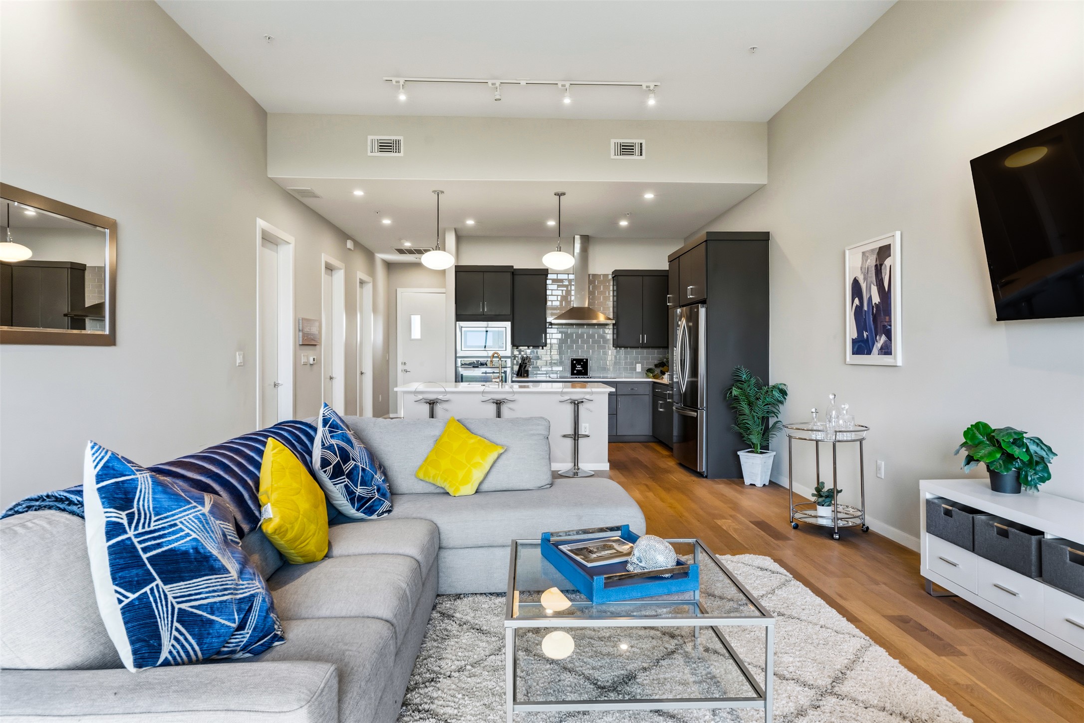 5921 Hiline Road, Unit 2304 Austin, TX 78734 - Photo 13 of 38 a living room with furniture and a flat screen tv