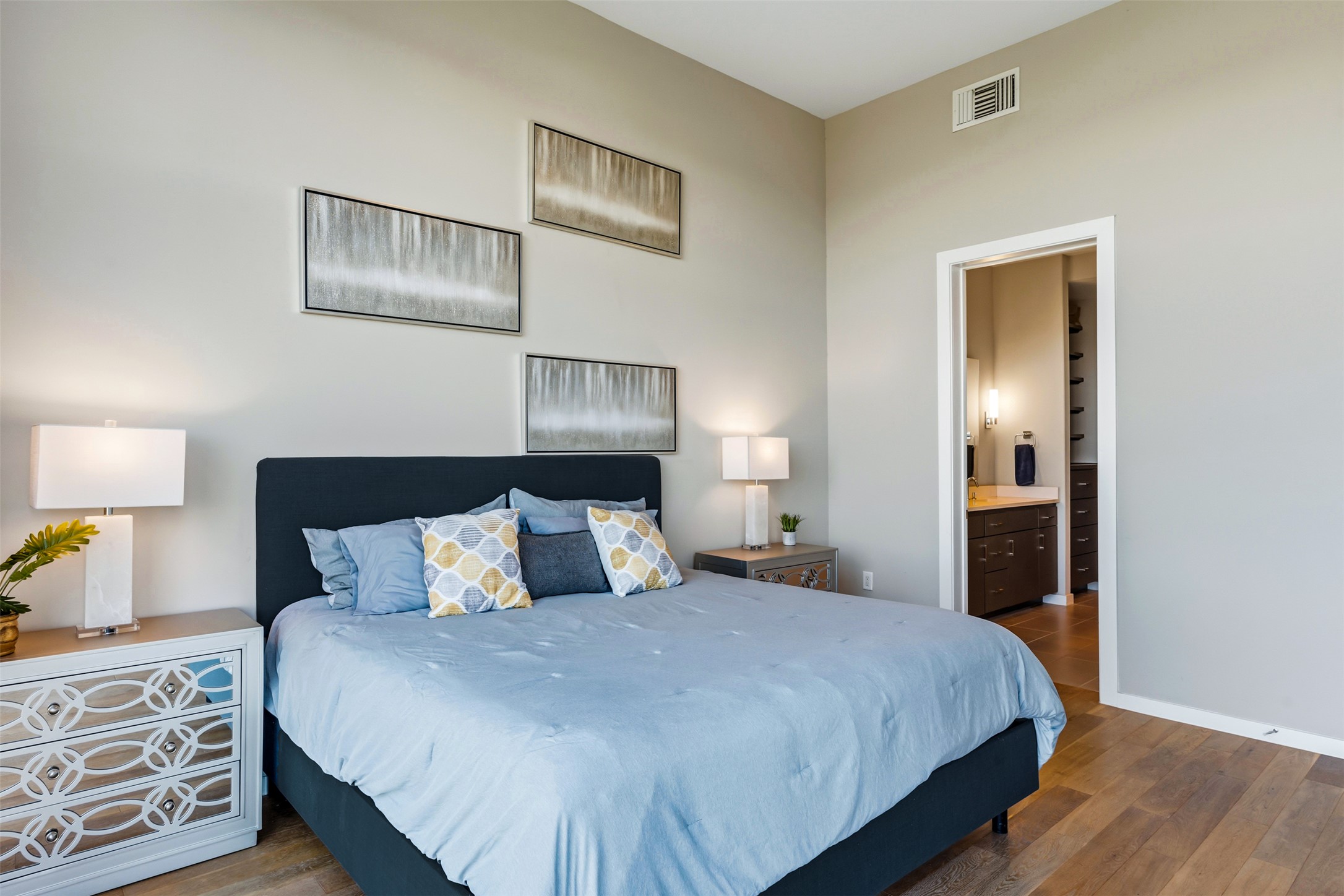5921 Hiline Road, Unit 2304 Austin, TX 78734 - Photo 21 of 38 a bedroom with a bed and a lamp on dresser