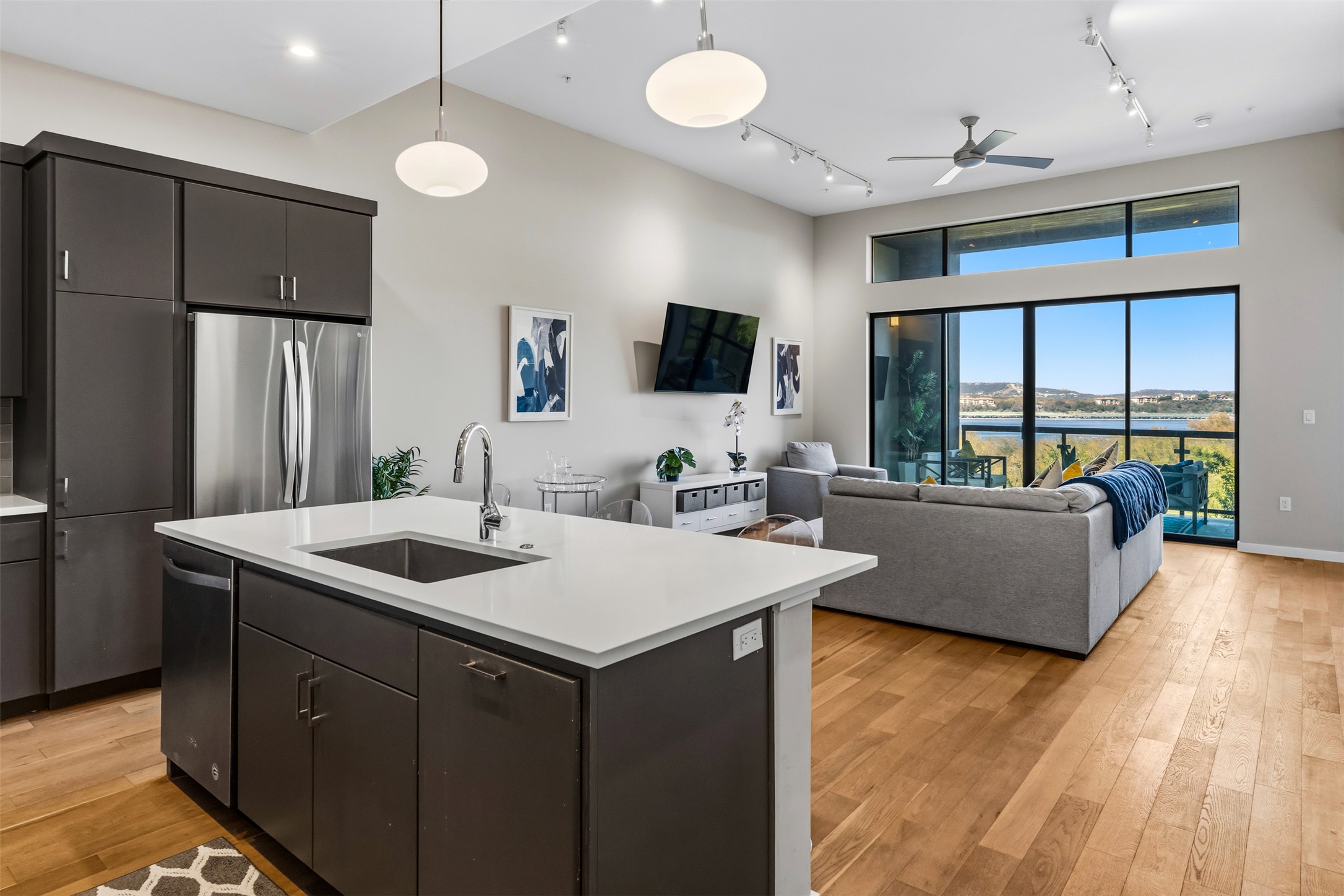5921 Hiline Road, Unit 2304 Austin, TX 78734 - Photo 38 of 38 Kitchen with open floor plan, a center island with sink, stainless steel appliances, track lighting, and a high ceiling
