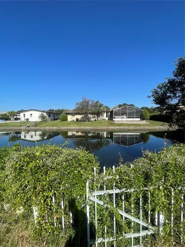 a view of a lake with houses in the back