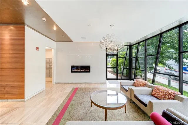 a living room with furniture and a chandelier