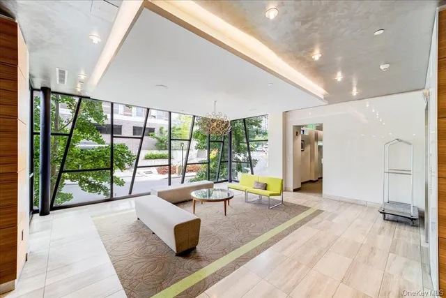a living room with furniture and large windows