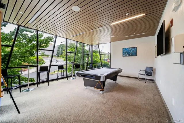 a living room with furniture tv and a large window