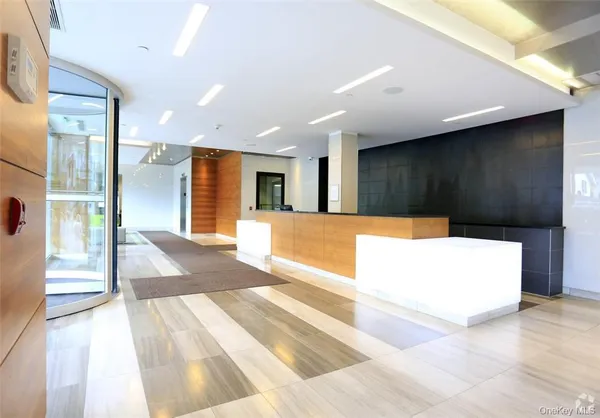 a view of a hallway with a couch and wooden floor